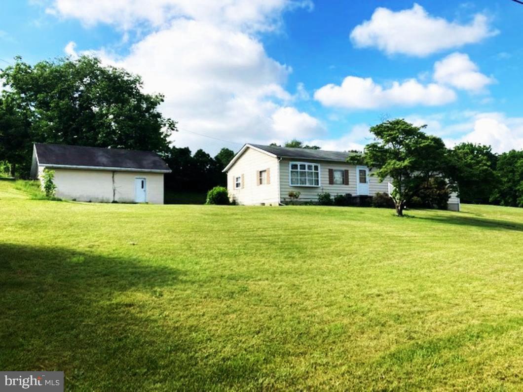5.3 acres  That  offers Great Potential !!Features a , clean, very well maintained home on a private setting.  Two separate metered levels. The main level includes very spacious kitchen, family and dining rooms, 3 bedrooms, mudroom, laundry room, one full bath, 
 and one half bath. The lower level includes a nice sized family room, kitchen/dining areas, two bedrooms, one full bath and a utility room.  The detached garage is oversized and includes a full-length storage attic  with separate entrance. The land is primarily open and flat to gentle sloping.  The Local Business Zoning provides for an abundance of permitted uses making this property an excellent owner-user property, or an investor-owned investment. There's about 390 foot of road frontage on MD RTE 27  but the entrance to the home is  on Wood Drive .