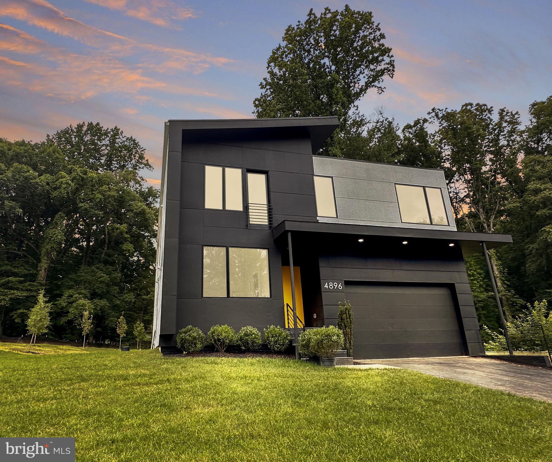Construction is complete and tastefully staged for you to picture yourself in this stunning modern single-family residence nestled in the heart of Annandale, VA. Designed by award-winning company KUBE, this luxurious 6-bedroom, 5-bathroom home is perfect for families seeking a stylish and spacious retreat. Upon entering, you'll be captivated by the open space living, dining, and kitchen areas that showcase double height ceilings, European-style kitchen with island, quartz countertops and backsplash, and sleek black stainless steel appliances. Beautiful wood floors adorn the first and second floors, while oversized windows flood the home with natural light and 10 ft high ceilings add an airy touch. The main level also boasts a den/office, perfect for remote work or study, and an expansive deck overlooking the serene, tree-lined backyard. The owner's suite features a private balcony, offering a peaceful haven to unwind after a long day. A convenient laundry room on the bedroom level and a cozy sitting area overlooking the open space below, deck, and backyard add to this home's thoughtful design. The walk-out basement is an entertainer's dream, complete with floor-to-ceiling windows, sliding doors to a private patio, and a wet bar with wine cooler. A bedroom and full bathroom in the basement provide extra space for guests or family. With 0.5 acres of land, and an unbeatable location, within minutes to Washington DC, new Amazon HQ, Ronald Reagan National Airport and nearby shopping, this Annandale gem is waiting for you to call it home. Don't miss the chance to experience modern luxury and timeless style at 4896 Columbia Rd.
