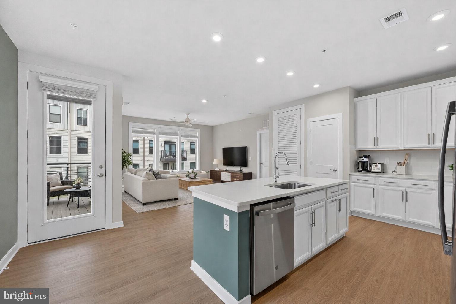 Welcome home to this nearly-new, impeccably upgraded condo in the heart of Reston!  Built in 2022, this exquisite 2-bedroom, 2-bathroom condo is nestled within the serene enclave of Tall Oaks. With 10-foot ceilings and expansive windows, the home is flooded with natural light, creating an airy, open feel that flows over elegant luxury vinyl plank flooring. The heart of the home is a gourmet kitchen featuring gorgeous stainless steel appliances, custom tile backsplash, under cabinet lighting and sprawling countertops—perfect for the home chef. The open-concept living area invites warmth and comfort, while custom, built-in closets have been thoughtfully integrated throughout the hallways and bedrooms to maximize function. Retreat to the spacious primary suite, which boasts a large walk-in closet with a fully custom organization system. Outdoor living is effortless with a private balcony for morning coffee, plus access to premium community amenities including the nearby Reston pools, tennis courts, and pickleball courts. The home includes a secured garage with a reserved parking spot in the under-building lot, along with access-controlled bike storage for added peace of mind. Perfectly situated about a mile from the Wiehle-Reston Metro Station and the Dulles Toll Road, this location offers unbeatable convenience for commuters. You're also just blocks from the W&OD Trail and an array of restaurants and shops, including those at nearby Reston Town Center. The monthly association fee covers water, sewer, trash, and common area maintenance, offering a truly turn-key lifestyle. Experience the perfect blend of modern luxury and suburban tranquility in Reston.