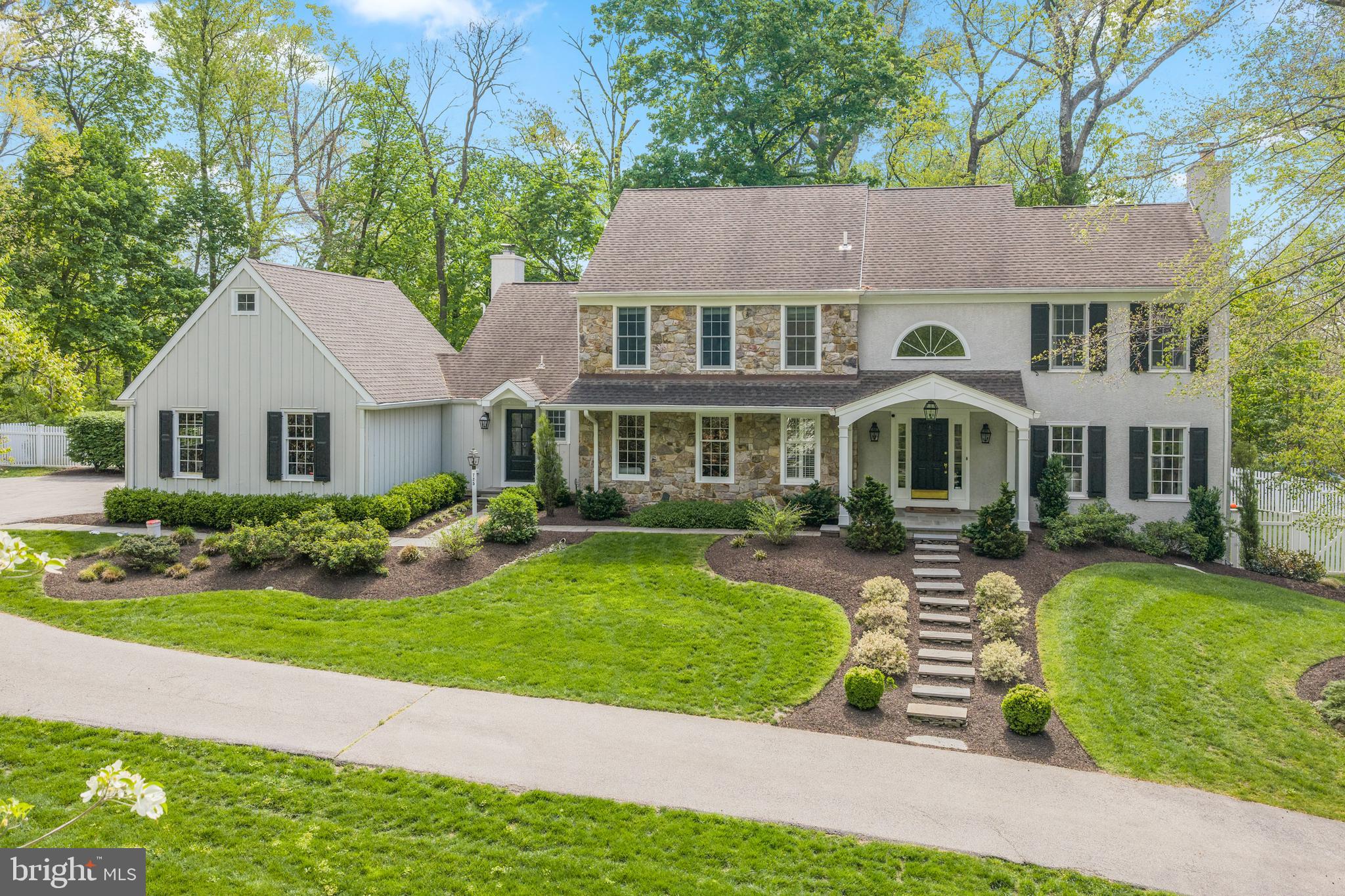 Welcome to 725 S Roberts Road, Bryn Mawr located in award winning Radnor Township, nestled peacefully down a long driveway. As you step inside the entry foyer, you're greeted by beautiful hardwood floors that flow seamlessly throughout, adding warmth and charm. The formal living room, featuring a wood burning fireplace, sets the tone for the home's elegance, providing a perfect space for relaxing and entertaining. Adjacent to the living room is a formal dining room with a large bay window that fills the space with natural light, creating the perfect atmosphere for dinner parties and family gatherings. The spacious eat-in kitchen has custom cherry cabinetry, granite countertops, center island, as well as an eat-in area. The kitchen flows effortlessly into a large, light-filled family room with vaulted ceilings, gas fireplace, custom built-ins, and a custom bar area perfect for your entertaining needs. Just off the kitchen you'll find a newly renovated mudroom/ laundry room equipped with radiant heat flooring and plenty of storage for your daily convenience. For those who need a quiet space to work, there is a private office on the first floor featuring built-in bookcases throughout. The first floor is completed by a newly renovated powder room and a large 2 car garage. Upstairs, the lovely primary suite serves as a tranquil retreat with a newly renovated primary bath and a custom built walk in closet. The three additional bedrooms are serviced by a newly renovated full bath in the hallway featuring bright white tile and cabinetry. The large, finished lower level is appointed with a seating area, bonus room and a full bathroom. Outside, the home sits on a sprawling one acre lot, with a lush private backyard featuring a natural bluestone patio. The backyard offers endless possibilities for outdoor living. You do not want to miss this spectacular property in Radnor Township!