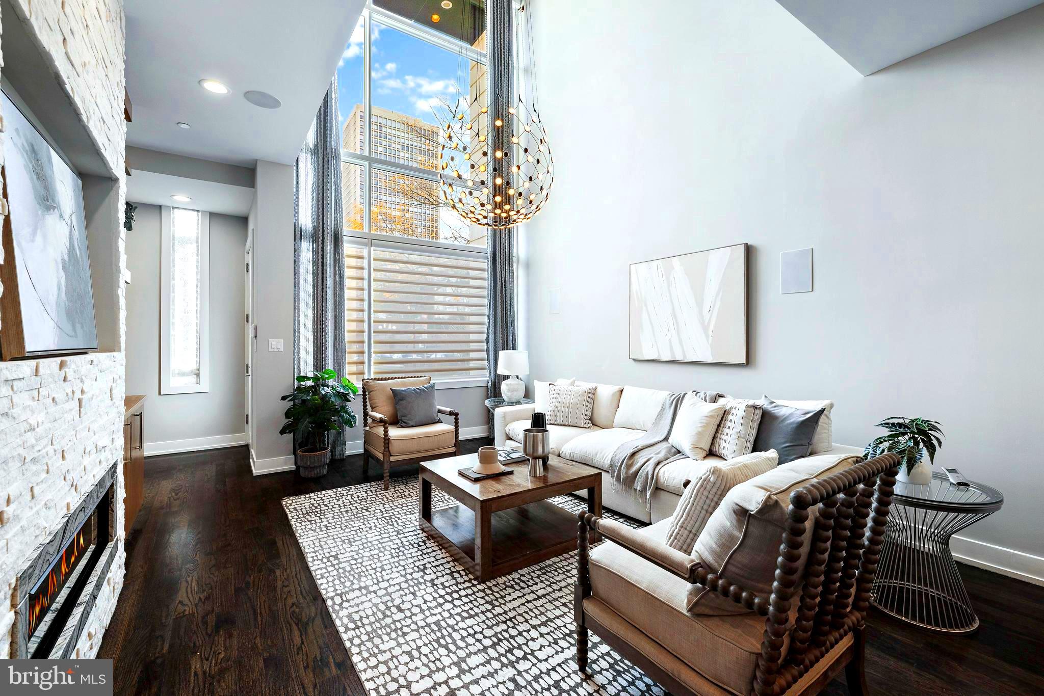 Located in the  heart of Society Hill, welcome to The Estates on 3rd Street. 214 S 3rd Street showcases as the original model unit of these renowned estates that offers a  distinct architectural design. Built in 2018, this property is truly the epitome of luxury and elegance.
The grand entrance, is one of the many  extraordinary features of the house. The expansive layout spans 4,583 square feet and boasts impressive 20-foot ceilings, allowing for an abundance of natural light to fill the space through the tall windows.

The first floor  is truly impressive, featuring a spacious living area . The exposed brick wall, adorned with wood cabinetry and floating shelves, creates a stunning visual centerpiece. You'll also find a built-in speaker system and a gas fireplace, adding to the overall ambiance of the room.

The living area seamlessly transitions into the dining area, which easily accommodates a large dining table. The gourmet chef's kitchen is a true masterpiece, equipped with top-of-the-line Sub Zero appliances, stone counter-tops, a custom back-splash, and meticulously crafted cabinetry. Additionally, a powder room is conveniently located on this level, and direct access to the  key code gated parking area at the rear .

Moving up to the second level, is the extraordinary primary suite  of luxury living. The elevated ceilings create an atmosphere of grandeur, while the suite offers two separate enter-in closets, a built-in wet bar, and a  deck. The primary bathroom is flawlessly designed, featuring a translucent glass shower, a freestanding bathtub, controllable heated floors, and a custom-designed vanity with a wardrobe-style layout, two sinks, and large mirrors.

The third level  consists of two generously sized bedrooms, each with its own full bathroom, enter-in closets, built-in shelving, and large windows that allow for ample natural light. Additionally, there is a convenient laundry room on this level, complete with an extended counter top, a sink, and attached cabinets for added storage.

The fourth level  is equally impressive, offering additional amenities . Here, you'll find a full wet bar, a sitting nook or office area, and access to the attached outdoor deck located at the rear . On the opposite side of the fourth level, there is a sizable bedroom with a full bathroom and an open-sized closet, making it ideal.

Luxury living extends to the finished basement, which can be  accessed via the full-stop elevator. This space features a media room, a wet bar, a powder room, and ample storage space . The media room opens up to a gym equipped with two enter-in closets . The house is also equipped with various smart tech features, including a key-pad security system and an installed video intercom system for convenience. Tax Abatement!

 Experience firsthand the meticulous craftsmanship and attention to detail that has gone into creating this exceptional property.