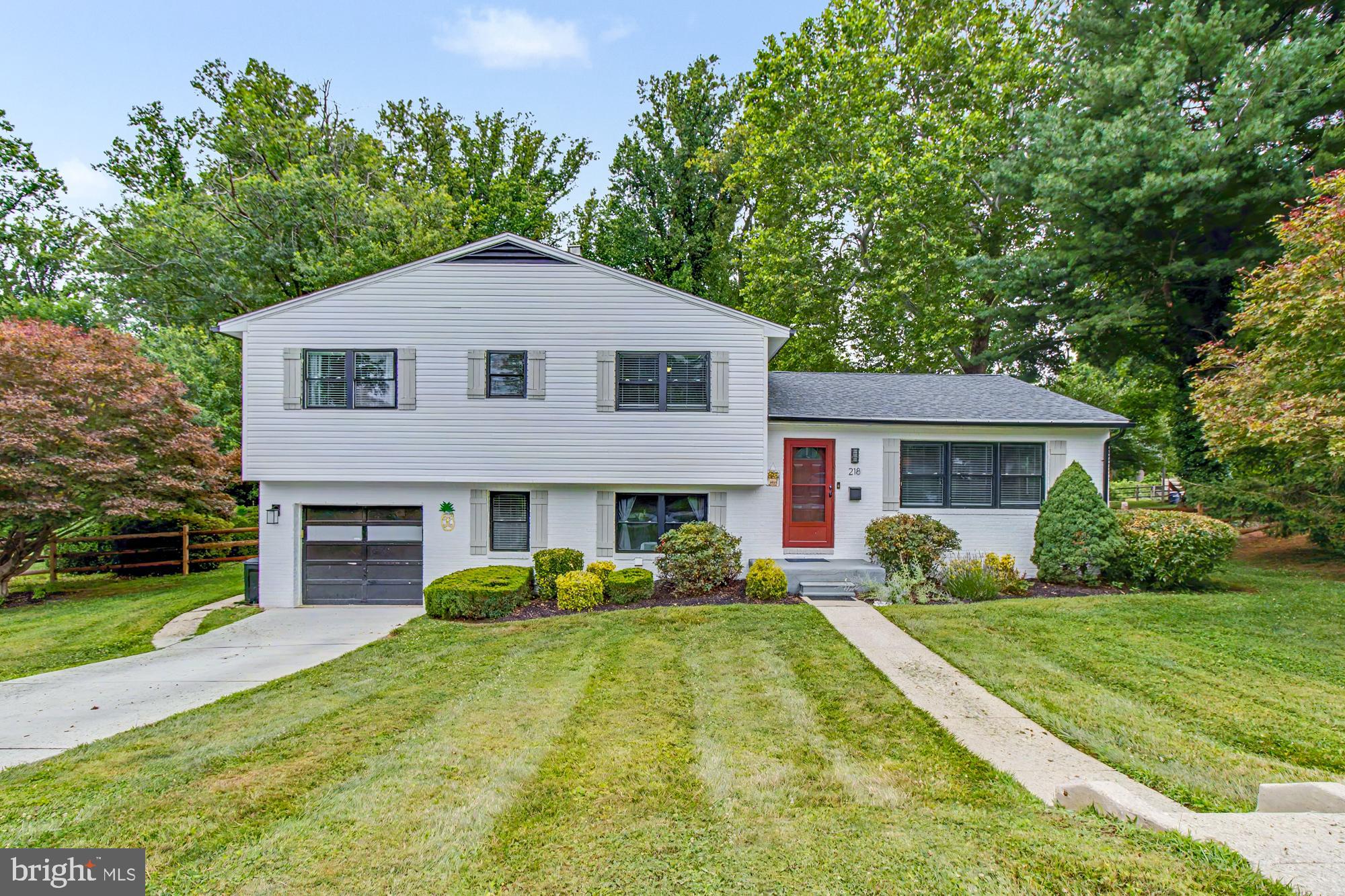 Charming Updated Split-Level on a Private Half-Acre in Waterford — Lutherville-Timonium
Set on a level half-acre lot backing to woods in the sought-after Waterford community of Lutherville-Timonium, this beautifully updated 4-bedroom, 2.5-bath home offers 2,174 square feet of thoughtfully maintained living space with hardwood floors throughout the main and upper levels. A 2021 renovation transformed the kitchen and all three bathrooms, bringing a warm yet contemporary, almost coastal-inspired aesthetic throughout, with brushed champagne fixtures carried consistently across the main and upper levels. The kitchen is fully open to the living and dining areas, anchored by a striking navy island with quartz countertops that contrasts beautifully against crisp white cabinetry. A horizontal modified white subway tile backsplash with champagne metallic accents ties the space together, along with a black stainless refrigerator and black gas range.
The primary suite is a true retreat, with a spa-like bath featuring a stunning blue-and-white patterned tile floor that flows seamlessly into an oversized glass shower, framed in brushed champagne hardware with a sleek sliding door, rain shower head, and handheld sprayer. A large-format tiled surround with a designer niche accent and a modern industrial-style vanity light with black-and-brass cylinder sconces complete the space. The hall bath, updated in the same 2021 renovation, features its own eye-catching geometric tile floor, and a lower-level powder room rounds out the home's three fully renovated bathrooms.
The lower level also offers a versatile recreation room and a dedicated laundry room, with a walkout to a covered porch overlooking the private, fenced half-acre backyard — a rare combination of space, privacy, and quiet in this location.
Recent updates add real peace of mind: new driveway (2023), new fence (2025), new front door and storm door (2025), electric/invisible fence (2024), new Bosch dishwasher (January 2025), most blinds replaced (2023), and an active Constellation maintenance plan covering both the HVAC system and water heater. Attached single-car garage, public water and sewer, and a location close to Towson, Hunt Valley, and I-83 commuter routes round out the appeal.
Move-in ready, meticulously updated, and offering the kind of private, tree-lined lot that rarely comes available in Waterford.