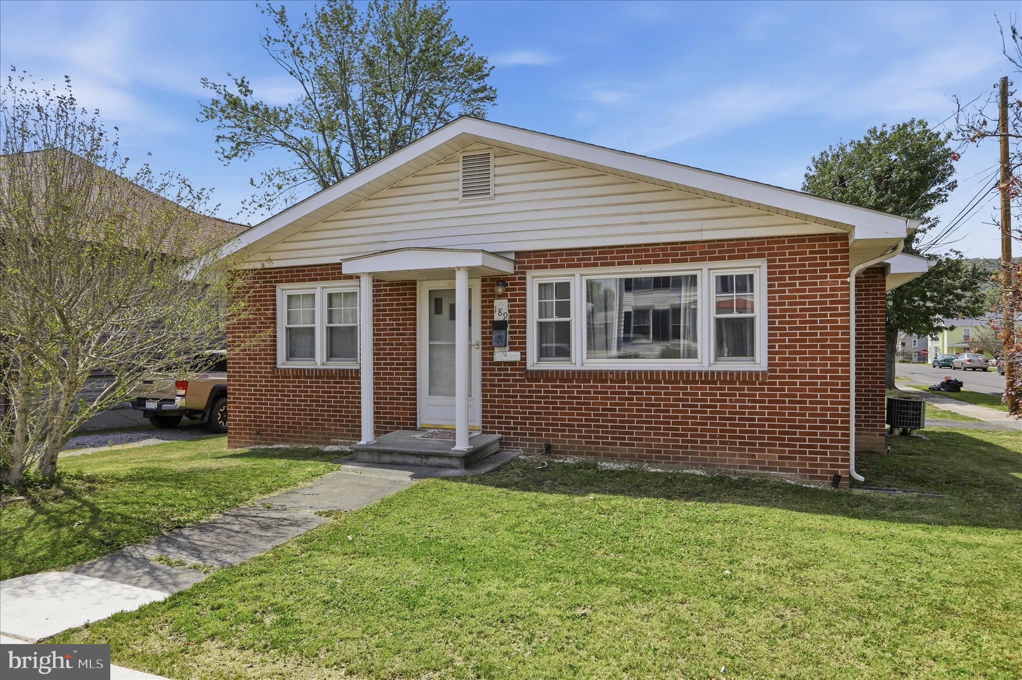 Well-built brick home in the heart of downtown Romney, offering excellent accessibility with convenient main-level living and easy entry through the front door. Located just a couple of blocks from Main Street, this home combines in-town convenience with comfortable living spaces. Inside, you’ll find a large, well-lit living room perfect for relaxing or entertaining, along with nicely sized bedrooms that provide ample comfort. The home is also equipped with central A/C for year-round comfort and presents an affordable opportunity for in-town living.

Outside, enjoy an easily maintained yard complete with a storage shed, while the oversized attached carport provides not only covered parking but also versatile bonus space for outdoor living or gatherings. The property also features outstanding storage options, including a spacious utility room off the attached carport and a basement with interior access, giving you plenty of room for organization and additional use.
