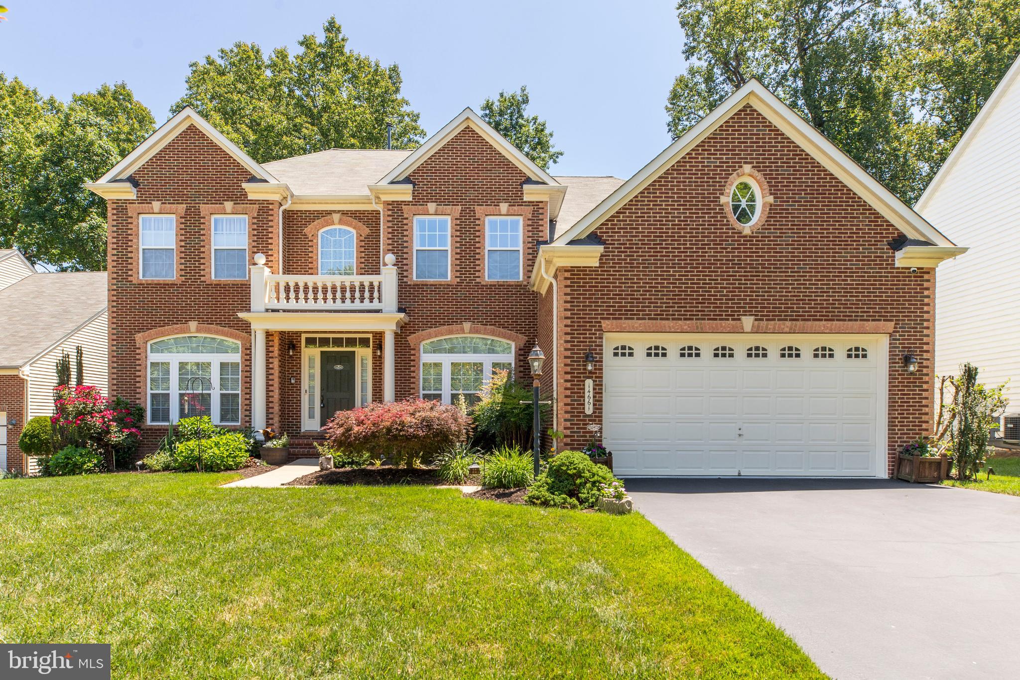 Welcome to 14661 Harry Allen Place — a stunning brick-front estate by NV Homes, a premier luxury home builder, offering over 5,300 finished square feet of thoughtfully designed living space on a quiet crescent in Woodbridge. Backing to a beautifully landscaped, private backyard lined with mature evergreens, this 6-bedroom, 5 full bath home combines luxury, comfort, and exceptional functionality.

The impressive two-story family room features a dramatic stone-faced gas fireplace, built-in surround sound, soaring ceilings filled with natural light, and elegant Brazilian cherry hardwood flooring throughout the main level. Ceiling fans throughout the home add comfort and efficiency year-round.

The gourmet kitchen is equipped with granite countertops, upscale cherry cabinetry, high-end KitchenAid appliances, built-in wall oven and microwave, powerful multi-speed exhaust fan, and a spacious walk-in pantry.

Upstairs, the elegant primary suite offers a tray ceiling and spa-inspired bath with dual vanities, Jacuzzi tub with jets, and central vacuum with outside exhaust for added convenience. All bathrooms feature granite countertops and quality cherry cabinetry throughout.

The fully finished walk-out basement provides incredible flexibility with a large bedroom, full bath, finished storage areas, expansive media room with built-in surround sound, and an impressive bar area complete with granite counters, sink, dishwasher, upscale cabinetry, and extra power connections — ideal for entertaining or creating a future separate living space.

Additional highlights include brand-new Carrier high-efficiency furnace and AC system (April 2026), dual-zone HVAC systems, maintenance-free deck with decorative lighting, resort-style backyard, 8-zone irrigation system, central vacuum system with 15+ inlets, wired security system, Cat5/Cat6 networking throughout, custom double-motion blinds, extended high-ceiling garage, and extra-long driveway.

This exceptional home offers the perfect combination of space, privacy, technology, and luxury in a highly desirable location close to shopping, dining, commuter routes, and everyday conveniences.

The Quartz District, located near Minnieville Road and Prince William Parkway in Woodbridge, is an active mixed-use development area with residential, retail, dining, and entertainment components planned and under development.