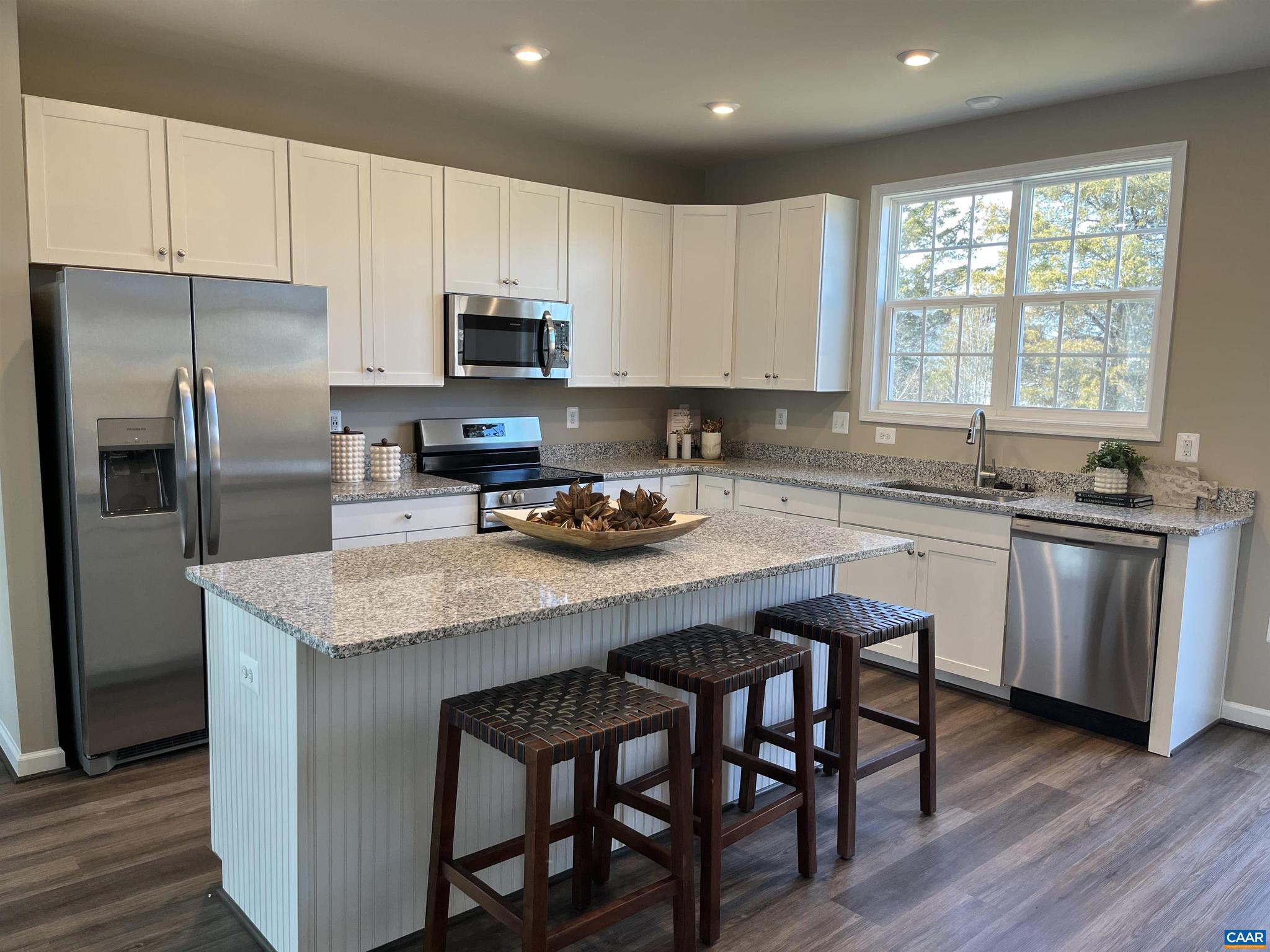 Immediate Move-In! This stunning 3-level townhome offers over 1,850 sq. ft. of beautifully finished living space, complete with a 1-car garage. Featuring 4 bedrooms and 3.5 baths, this home is designed for comfort and style.  The rear kitchen layout boasts a 6-foot island, 42" cabinets, a step-in pantry, quartz countertops, and stainless steel appliances. The owner?s suite includes dual vanities, a step-in shower, and a spacious walk-in closet. All baths and the laundry room feature ceramic tile floors and shower surrounds.  Additional highlights include LVP flooring in the foyer, kitchen, family, and dining rooms, plus a security system for peace of mind. HOA covers lawn care for easy living.  Photos and virtual tour may contain options that are not standard on all models or not an included feature. Pictures and virtual tour are of a model home and show optional upgrades.  Ask about current incentives when using our preferred lender and title company!,Maple Cabinets,Quartz Counter