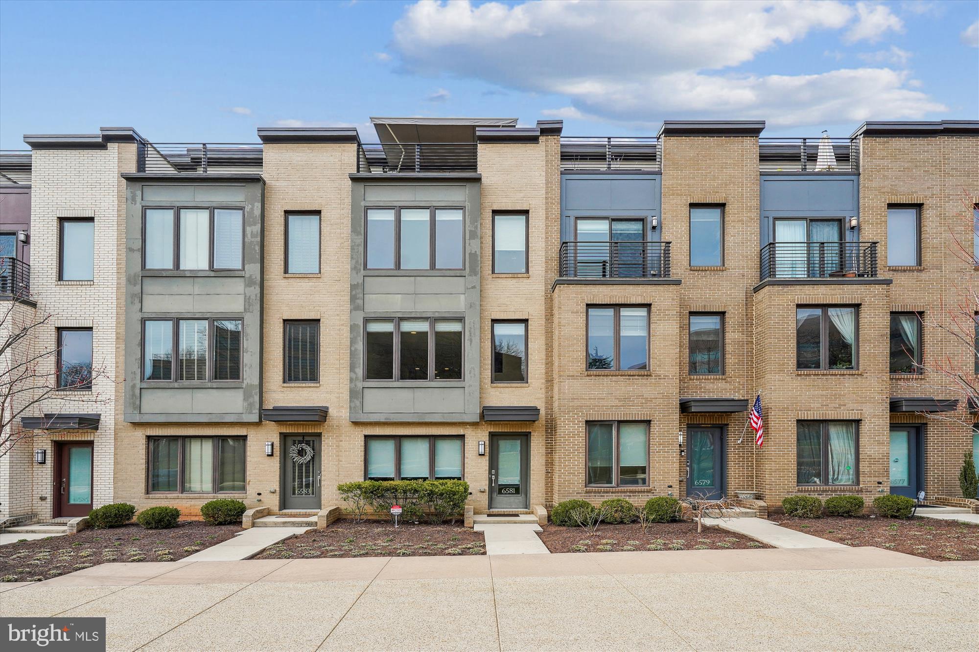 Discover the best-kept secret in Bethesda—Montgomery Row, an exquisite EYA contemporary community built in 2016. Ideally situated for commuters, shoppers, and culinary enthusiasts alike, this stunning home offers the perfect balance of luxury and convenience. This sundrenched outer row home offers an unmatched peaceful, open, and airy water view unobstructed by other townhomes for a tranquil oasis within an urban setting. Each of the 3 bedrooms includes its own en-suite bathroom to ensure privacy and comfort for everyone. The thoughtful design blends modern elegance and a coveted 2-car garage. One of the standout features for this home is the upper-level loft and top floor patio that affords access to take in the best nature view of any other townhome in the neighborhood: a pond framed by ever-changing foliage, including cherry blossoms in springtime.  This is truly a 3-season retreat, equipped with a retractable sun awning for shade on summer days, an outdoor gas fireplace to keep you cozy on fall nights while sipping your coffee or wine, and a custom upgraded gas line for year-round grilling. This outdoor space is perfect for both relaxing and entertaining. With over $51K in upgrades, this home exemplifies attention to detail. Highlights include high-quality blinds, a central vacuum system, oak stairs, an upgraded appliance package, quartz countertops, upgraded tile and a frameless glass shower door. The owner's bedroom and bathroom boast high ceilings, a walk-in closet, and a beautiful owner's bathroom complete with a double vanity and stunning luxury shower. The main living level is light and bright to evoke Malibu beach house vibes. The open concept design allows ample kitchen work space that flows into a dining area and lounging and entertainment space. Montgomery Row is a vibrant community offering a wonderful play area, electric car chargers, and professional grounds maintenance and multiple parking options. You’re minutes from I-270, I-495, Old Georgetown Road, and Rockville Pike, not to mention an array of dining, shopping, and entertainment options, including Baldacci’s, Starbucks, Montgomery Mall, Pike and Rose, and more.