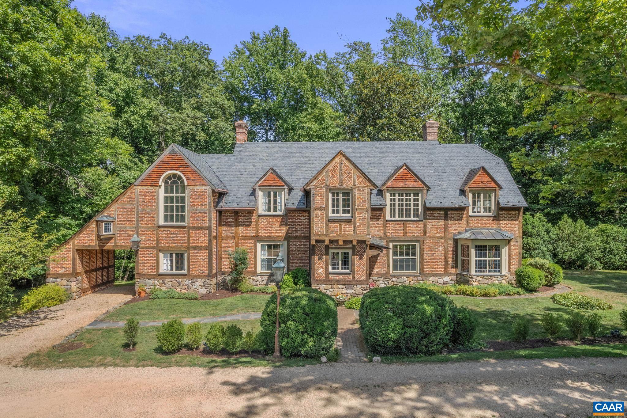Creoch--Ideally located just 5 miles west of Charlottesville along the beautiful Garth Rd. corridor, this unique Albemarle estate features a grand 5-bedroom brick manor house (c.1912), a spacious 4-bedroom guest house/2nd dwelling, and a cozy 1-bedroom cottage, all on 17 picturesque acres. Privately situated at the end of a quiet country lane, the rolling acreage includes a large, fenced pasture, spring-fed pond, hardwood forest, and mountain views. The main house of over 6000 sq. ft. is an authentic Elizabethan half-timbered Tudor, with antique and reclaimed materials from the surrounding region, including hand hewn oak timbers, 200-year-old handmade brick, roofing slate and wood flooring. Inside, this magnificent home is formal in scale and proportion, yet charmingly unpretentious, warm and welcoming. The 2nd dwelling, appealingly private from the main house, has evolved into a comfortable home of   3700 sq. ft., with fine materials, generous spaces, and delightful pool area.  Both homes are lushly landscaped. With magnificent scenery from an unspoiled viewshed surrounded by over 500 protected acres, Creoch?s peaceful location is absolutely unbeatable. Offered for sale for the first time in 45 years.,White Cabinets,Wood Counter