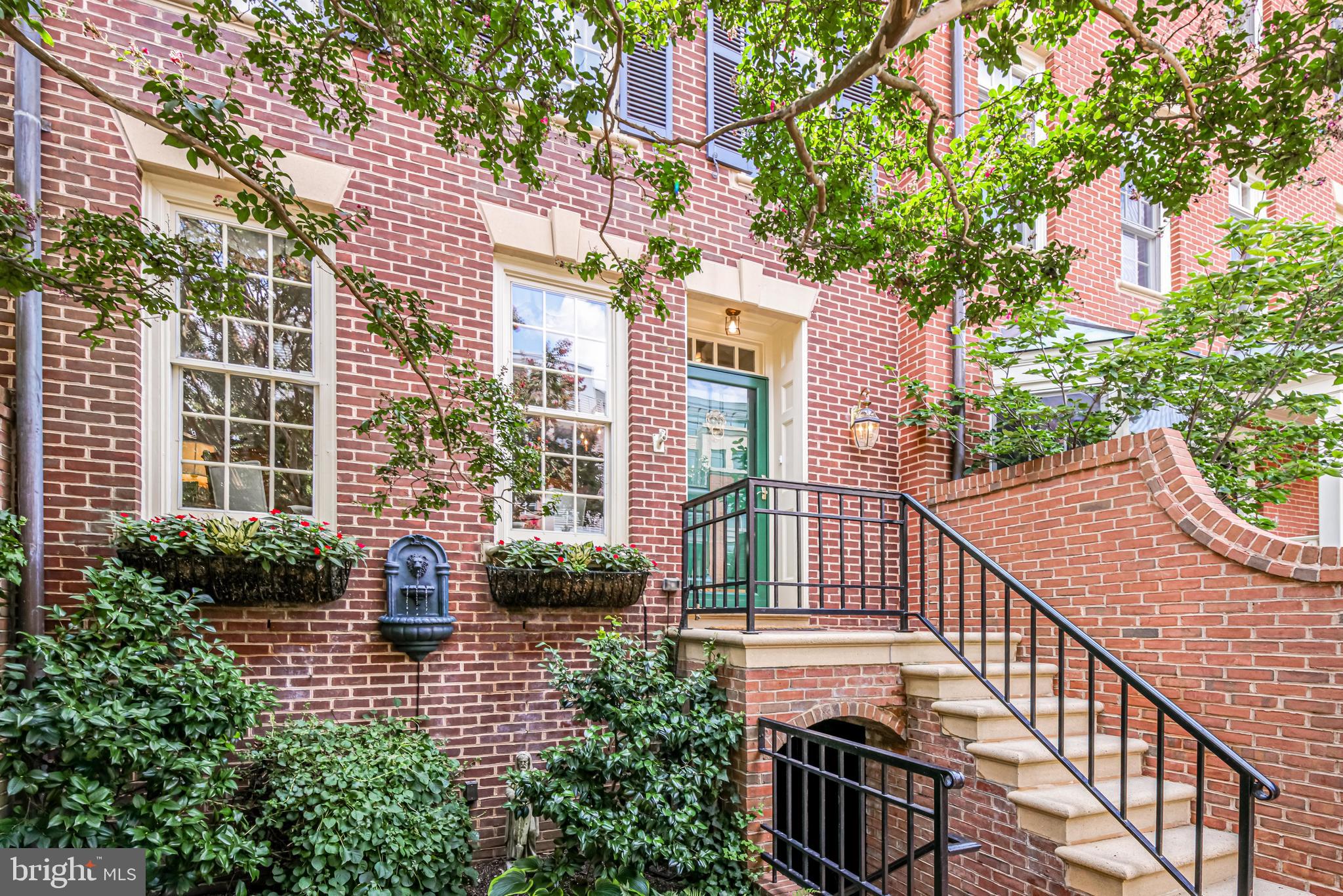 This Harborside treasure with triple exposures has the flow of an elegant single-family home. The quality of the craftsmanship and classic features are abundant in this three-level, four bedroom, 3.5 bathroom home.  You enter from a welcoming front brick-walled patio into a beautifully appointed floor plan that works for both family living and entertaining.  The first level with spacious room sizes consists of  living room with fireplace,  dining room, kitchen and family room with fireplace.  The family room has floor to  ceiling french doors that lead to a two-level outdoor entertaining area with a peek of the Potomac River.  The second level boasts a spacious primary bedroom with elegant en-suite bathroom, walk in closet and handsome built-ins, The second bedroom is used as a large home office with many of built-ins. Level three consists of two large bedrooms and an abundance of closet space.  Two deeded parking spaces convey. This premier location is just steps to the Potomac waterfront restaurants, King Street shops and restaurants and all the Old Town has to offer!