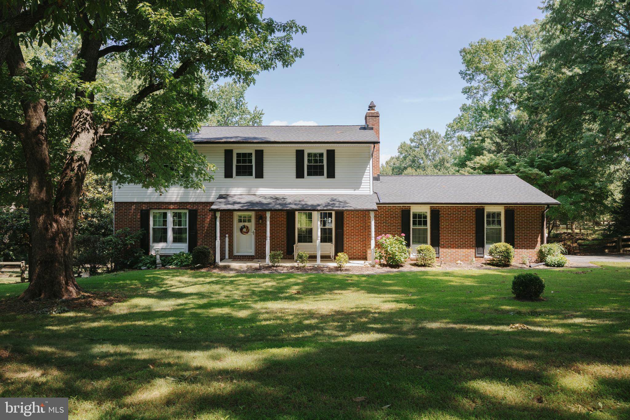 Tucked into one of the area's most established and picturesque neighborhoods, this beautifully updated home offers the perfect blend of timeless charm and modern living on nearly a full acre, complete with a beautiful, level backyard that's perfect for entertaining, gardening, gathering with friends, or simply enjoying the outdoors.

From the moment you arrive, you'll appreciate the peaceful setting, mature trees, and welcoming curb appeal. Inside, the heart of the home is the spectacular, fully renovated kitchen. Thoughtfully redesigned by removing walls to create an open, expansive gathering space, it features stainless steel appliances, abundant workspace, cooper sink, custom tile backsplash, and the kind of layout that naturally brings everyone together. Whether you're hosting holiday dinners or enjoying a quiet morning coffee, this kitchen truly becomes the center of the home.

The main level also offers a formal dining room for memorable gatherings, complete with a wood-burning fireplace, creating a warm and inviting space for entertaining.

Upstairs, you'll find four comfortable bedrooms, including a spacious primary suite with a walk-in closet and private en suite bath. The additional bedrooms offer flexibility for family, guests, a home office, or hobbies.

Downstairs, the finished lower level provides an exceptional family room with endless possibilities for movie nights, game days, a playroom, home office, or home gym, while still offering an impressive amount of storage space. An attached two-car garage adds everyday convenience.

Step outside and you'll discover one of this home's greatest treasures. The spacious rear deck overlooks the beautiful, level backyard, creating the perfect spot to relax, entertain, or simply take in the peaceful surroundings. There's plenty of room for gardening, outdoor games, pets, or creating the backyard you've always envisioned.

The owners have invested extensively in the home, providing tremendous peace of mind for the next owners. Major updates include a remodeled kitchen with stainless steel appliances (2022), roof, gutters, gutter guards, and downspouts (2024), 200-amp electrical panel (2022), Pella replacement windows (2018), HVAC A/C compressor (2017), heating oil tank (2019), well tank and water treatment system (2020), front door, sliding glass door, and three full-view storm doors (2020), plus a new 50-gallon electric water heater (2026).

Homes like this are special. A beautiful setting, thoughtful updates, generous living spaces, and an incredible yard come together to create a place that feels just as wonderful as it looks. This is the kind of home you'll look forward to coming back to every day.