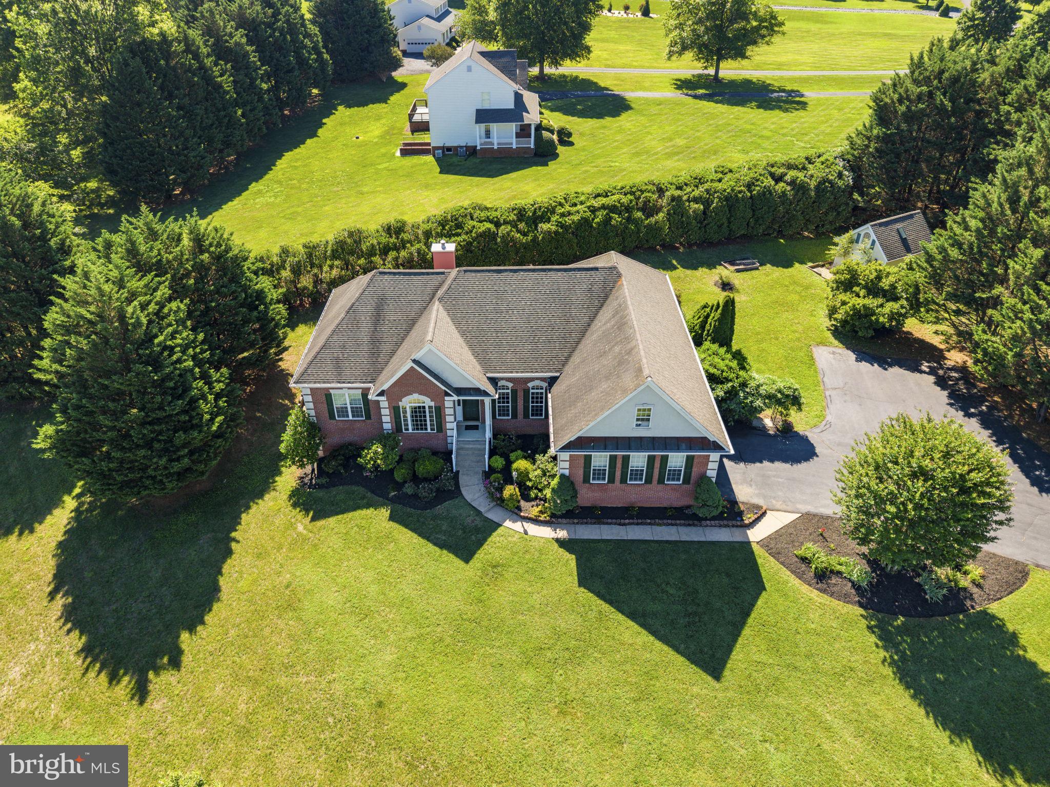 Welcome to Clairmont Manor! Nestled on a premium 1.6-acre lot backing to mature trees, this stunning 4-bedroom, 2.5-bath traditional rambler offers the perfect blend of elegant main-level living and private outdoor tranquility in one of Culpeper’s most sought-after neighborhoods.

With over 2,500 sq. ft. of finished living space, this home truly pops the moment you walk through the door. You'll love the high ceilings, beautiful hardwood floors, elegant crown molding, and sophisticated tray ceiling details.

Home Highlights:
Elegant Living Spaces: Enjoy a formal living room and a dedicated dining room perfect for hosting, alongside a large, cozy great room featuring a warm gas fireplace.

Chef’s View & Morning Coffee Room: The bright, separate kitchen boasts a lovely bay window overlooking the spacious deck and private backyard. Right off the kitchen, a charming morning coffee room offers the ultimate spot to start your day.

Private Primary Suite: Designed with a smart split-bedroom layout, the generous primary suite sits privately on its own side of the home, featuring a large ensuite bath and an expansive walk-in closet.

Flexible Layout: Two additional well-sized bedrooms share a full bath on the opposite wing. Upstairs, a huge bonus room over the garage makes the perfect home office, recreation room, or 4th bedroom.

Storage Galore: The main-level laundry room is packed with cabinets, surrounded by additional storage closets. Need more space? Walk around to the exterior-access lower level—a massive walk-in storage area ideal for lawn equipment and holiday decor.
Step outside onto your private deck to enjoy peace, quiet, and beautiful wooded views. 

This Clairmont Manor gem offers the space, privacy, and upscale details your buyers have been searching for!