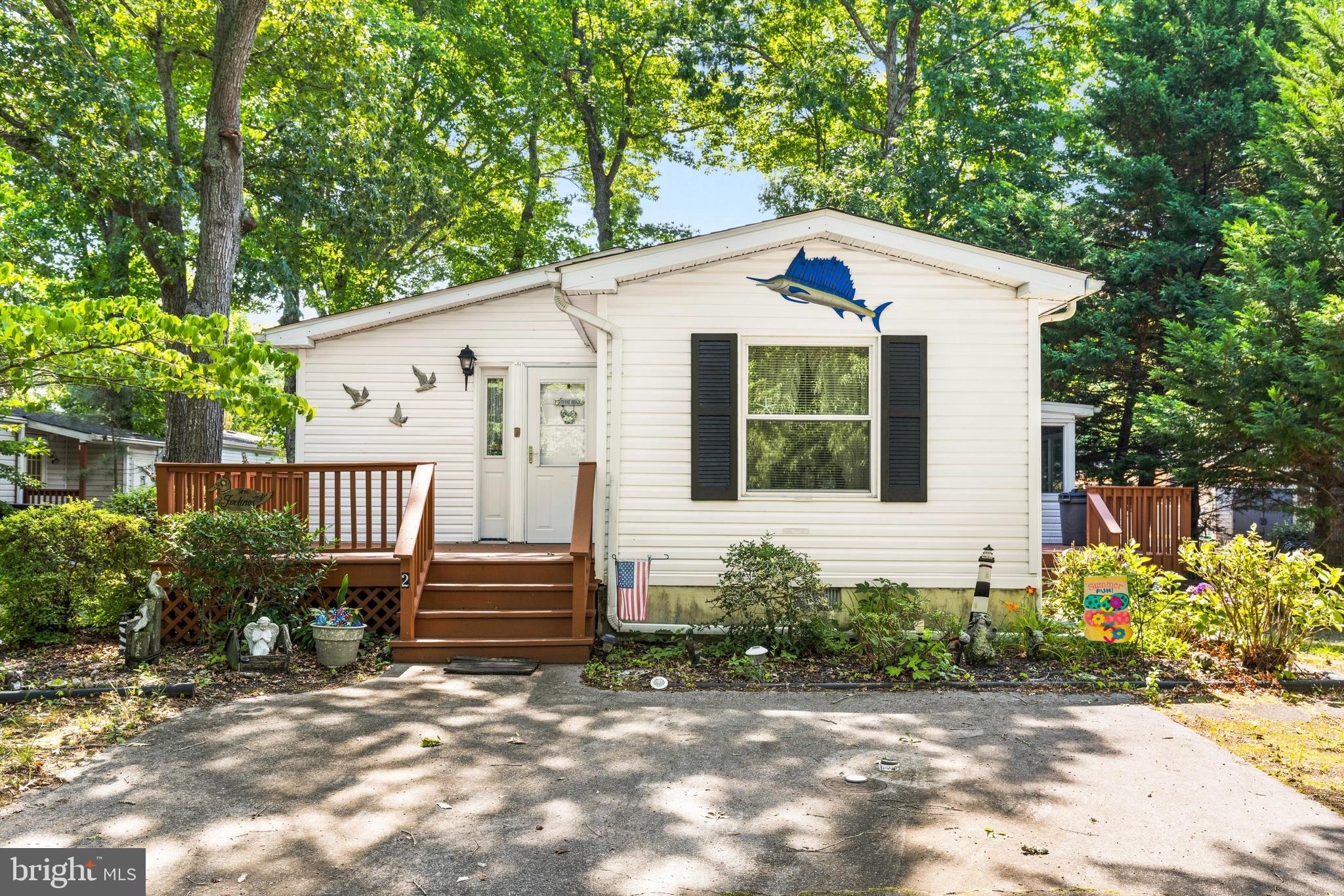 Welcome to this charming 2-bedroom, 2-bathroom home in the sought-after Mystic Harbour community,.  Whether you're looking for a full-time residence, vacation getaway, or investment property, this home offers the perfect blend of comfort, convenience, and coastal charm.

Step inside to find a bright, open floor plan with cathedral ceilings and spacious living and dining areas designed for both relaxing and entertaining. The well-appointed kitchen offers ample cabinet and counter space.

The primary suite features a private en-suite bathroom, separate sink and vanity area and generous  walk in closet space, while the second bedroom and full guest bath provide comfort and privacy for family and visitors.  Home sleeps 8.

Outside, enjoy a private backyard, 2 decks, and an enclosed patio—ideal for morning coffee, evening gatherings, or simply soaking in the peaceful surroundings. Low-maintenance living allows you to spend more time enjoying everything the Eastern Shore has to offer.

Residents of Mystic Harbour enjoy community amenities including an outdoor pool, tennis courts and playground area.   Located just a short drive from Ocean City, Assateague Island National Seashore, golf courses, restaurants, shopping, and marinas, this home puts the best of coastal Maryland right at your doorstep.

Don't miss this opportunity to own an affordable home in one of Berlin's most desirable  communities. Schedule your private showing today and discover the lifestyle you've been waiting for!

Recent upgrades include Roof 2021, Kitchen Skylight 2021, Pipes Replaced 2019, New Primary Tub and Bathroom Flooring 2019, Kitchen Floor 2019.

Home is sold furnished.