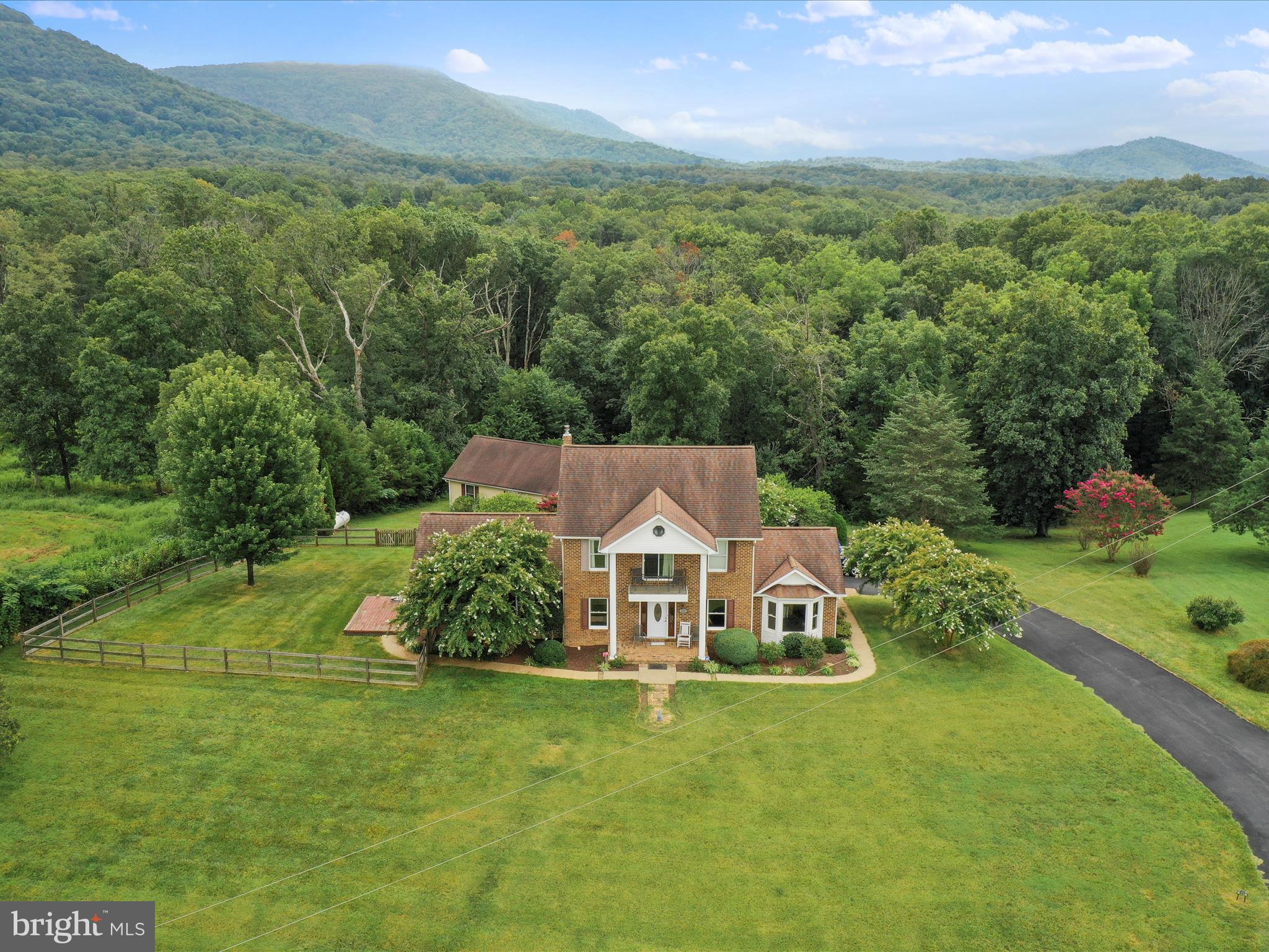 This home has the perfect blend of comfort, space, and scenic beauty nestled on 4.6 acres offering over 3,400 square feet of finished living space. Breathtaking mountain views surround the property, while a paved driveway leads you to the home and a detached two-car garage.
This 4/5-bedroom, 3.5-bath home is designed for both everyday living and entertaining. The heart of the home features a spacious kitchen with granite countertops, ceramic tile flooring, downdraft range, under-cabinet lighting, double wall oven, and a large dining area. An additional formal dining room flows into the living room, both accented with crown molding and chair railing.
The family room is warm and inviting with a gas fireplace (3yrs old), wood ceiling, and a built-in wet bar—perfect for gatherings. Hardwood floors (prof. cleaned) run throughout much of the main level, and the large laundry room offers convenience and storage.
The primary suite is a true retreat, boasting two custom closets, private balcony, and a luxurious ensuite bath with a walk-in tile shower, double vanity, and jetted tub.
Additional highlights include: a newer furnace (1–2 years old), 2-zoned central air, Generac whole-house generator (serviced), storage shed, and a blend of functional updates and timeless charm throughout.

Don’t miss this opportunity to own a stunning home with space, privacy, and picturesque surroundings—all just a short drive from town. (2.5mi from Front Royal)
