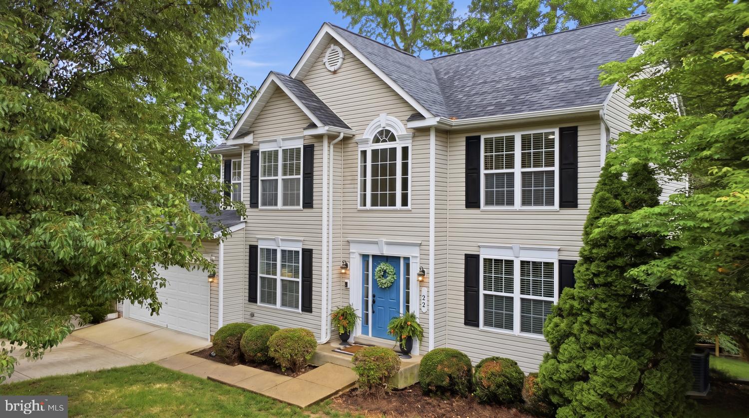 MUST SEE HOME!! Beautifully maintained and move-in ready, this spacious two-story home is tucked away on a peaceful cul-de-sac in the sought-after Jamestowne neighborhood, offering convenient access to Routes 301 and 210. The main level features newly installed luxury vinyl plank flooring, neutral paint, and thoughtfully designed living spaces throughout. The kitchen is appointed with maple cabinetry, newer quartz countertops, a center island, pantry, built-in desk workstation, and newer appliances including the refrigerator, dishwasher, and microwave. A built-in intercom and music system serves both the main and upper levels.The inviting family room is highlighted by a gas fireplace and large windows that provide plenty of natural light. In addition the first level has formal living and dining rooms, a private office or den with French doors, a refreshed laundry room, and a convenient powder room. Faux wood blinds throughout provide a cohesive finish.
Upstairs, the spacious primary suite features a large sitting room with a rough-in for a wet bar or coffee bar, a walk-in closet, and a freshly painted en-suite bath with dual vanities and a soaking tub. Three additional bedrooms complete the upper level, each with newly installed carpet, including two with walk-in closets, along with a shared full bath. The fully finished basement offers exceptional flexibility with a full bathroom, fifth bedroom or office, and an expansive 10' x 10' storage closet. A rough-in for a kitchenette or wet bar adds even more potential, making the space ideal for guests, multi-generational living, or a dedicated work-from-home setup.
Enjoy the peaceful wooded backdrop from the newly constructed Trex deck located just off the kitchen, complete with decorative lighting for relaxing or entertaining outdoors. Below, a beautifully stamped 600 sq. ft. walkout patio and matching stamped staircase lead to the driveway. Additional exterior features include durable vinyl siding, an 8-foot retaining wall, and a spacious two-car garage with room for storage and a workbench.
Major updates include a NEWER ROOF (2018), HVAC system (2016), and ENERGY-EFFICIENT WATER HEATER (2023). With its thoughtful updates, versatile living spaces, and tranquil cul-de-sac setting, this home offers the perfect blend of comfort, convenience, and functionality.