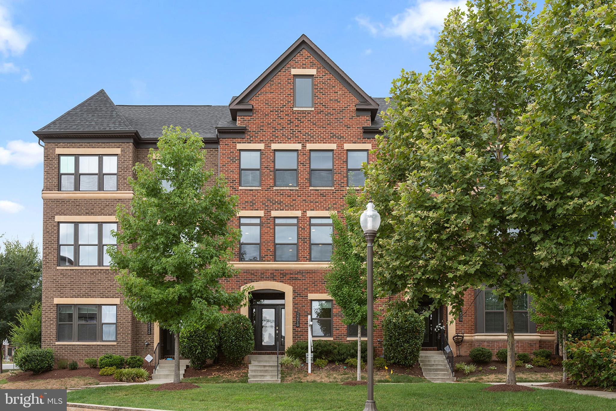 Exceptional Luxury Townhome in the Ashburn Westmoore at Moorefield Community with Tranquil Water Views, Distant Horizon Views, and Walking Distance to the New Ashburn Metro.  Shows Like a Model Home!  Quality Built NV Homes Ballston Model has an Amazing 4th Floor Loft with 2nd Owner’s Suite with Charming Window Reading Nook, Bonus Living Room, Full Bath, and Relaxing Rooftop Terrace.  Enjoy the Spacious Light Filled Floor Plan with 5BR, 5BA and over 3400 sq feet of Luxurious Living with upgrades like Designer Interior Paint, Gas Fireplace, Electronic Shades, Main Level Bedroom/ Office/Den with Wet Bar and Glass Doors, Mudroom Built-in, Bose Home Theatre Surround Sound, In Home Audio with Exterior Speakers, Covered 2nd Floor Lanai, Auto Sense Light Switches, Custom Garage Wall Storage and Cabinets, Built-in Wall Unit and Murphy Bed, All Closets have Custom Organizers, All Baths have Granite, a Grohe Blue Instant Pure Water System, Incredible Gourmet Kitchen and More. 

The Ground Floor Features Stylish Tile Flooring, Mud Room with Built-in Shelving off the Garage, Bathroom, Foyer, and Spacious Bedroom/Den/Office with Wet Bar, Recessed Lights, and Glass Doors.  The Garage is Loaded with Storage Cabinets and Wall Storage System.

The 2nd Floor is an Entertainer’s Delight with a Dramatic Light-Filled Wide Open Floor Plan, Engineered Wide Plank Hardwood Floors, In-Ceiling Speakers, Separate Dining Area with Water Views, Living Room with Gas Wall Fireplace, Large Covered Rear Lanai with 2 Sliding Glass Doors with Electronic Blinds, and Amazing Gourmet Kitchen.  The Kitchen is Outstanding and Boasts an Oversized Eat-in Island, Granite Counters, Pendant Lighting, Bosh Dishwasher, Grohe Blue Instant Pure Water System, GE Monogram Stainless Appliances with 5 Burner Gas Cooktop, Chefs Hood, French Door Refrigerator, Wall Oven, Subway Tile Backsplash, Soft Close Cabinets, and Large Pantry with Custom Organizer.

The 3rd Floor Features a Private Owner’s Suite with Engineered Hardwood Floors, 2 Large Walk-in Closets, and Luxury Bath with Tiled Shower, Double Vanity, Granite Counters, Huge Linen Closet, and Bidet.  There are 2 large Secondary Bedrooms one with a Built in Wall Unit with Murphy Bed, a Tiled Hall Bathroom with Double Vanity and Bidet, and a Convenient Laundry Room with Front Load Washer and Dryer, Tile Floor, and Cabinets. 

The 4th Floor Loft is an Incredible Living Space.  It has a Large Carpeted Bonus Living Room with a Built in Bose Home Theater System, Rooftop Terrace with Outdoor Speakers, Full Bath with Slate Tile Floor and Bidet, and Spacious 2nd Owner’s Suite / 5th Bedroom with a Cozy Reading Nook with Built-in Window Bench Seat, Bookcase and Wonderful Scenic Vistas.    

Additional Features include Hardwood Stairs, Tankless Hot Water Heater, Alarm System with Doorbell Camera, CAT 5 Cabling Throughout, Dual Zone HVAC with Nest Thermostats, and Custom Blinds Throughout. 

This Elegant Brick Townhome is a True Show Place and has a Superb Location Right Next to a Quaint Courtyard and just a Short Walk to the Incredible Community Amenities and Water Views!   The Amenities Include a Resort Style Community Pool, Expansive Club House, 24 Hour Fitness Center, Yoga Studio, Commercial Kitchen, Community Patio, Biking and Walking Trails, Two Community Grills, Two Community Parks, both with Large Tot Lots, and a Dog Park Area.  The Largest Community Park also has an Amphitheatre for Summer Concerts.  Westmoore at Moorefield also  Offers Easy Access to the Dulles Toll Road, Dulles Airport, Schools, Day Care, and Walking Distance to the New Ashburn Metro, Ashburn Station Shopping, Restaurants, and Movies.
