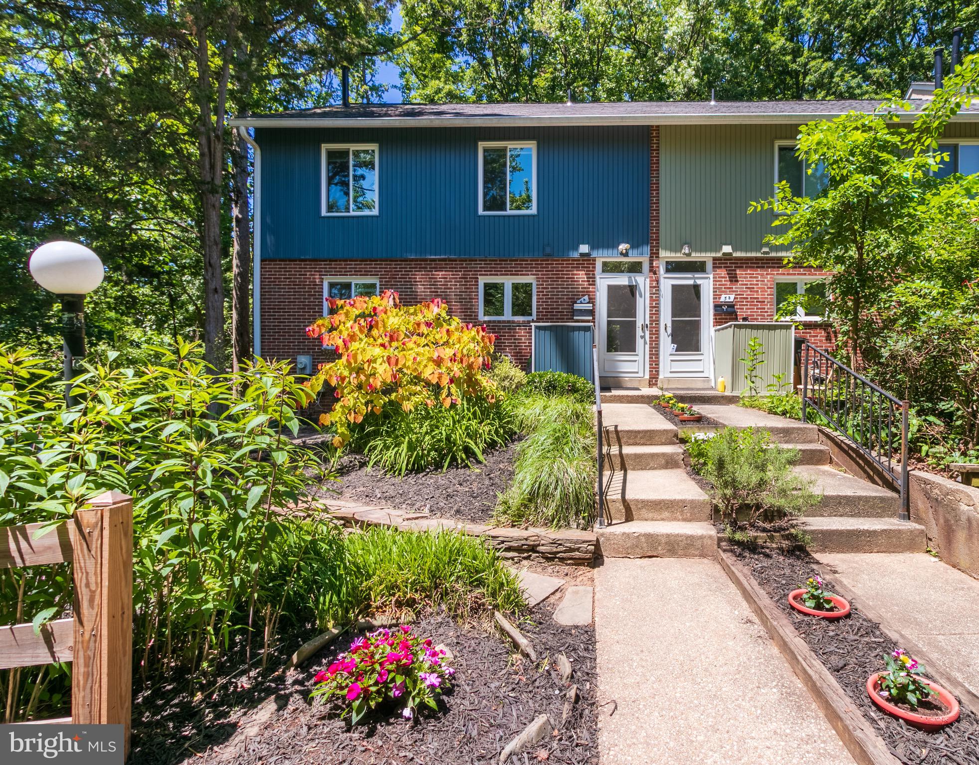 Words and photos are just not enough to explain how nice this home is, you must see for yourself.  This end of the row townhome features an immaculate landscape with plants and flowers that really inspire.  This gem backs to woods which provides peace and calm year round.  It has four bedrooms on the upper level with the primary bedroom having its own access to the over sized bathroom.  The main level has the most beautiful original hardwood floors one could ask for.  The bonus sunroom with sliders on all three sides is a wonderful entertaining area and has many more possibilities.  The basement is wide open with its own full bath.  The laundry room is perfect for extra storage or a possible arts and crafts area.  This home will not last long so come take a look for yourself.