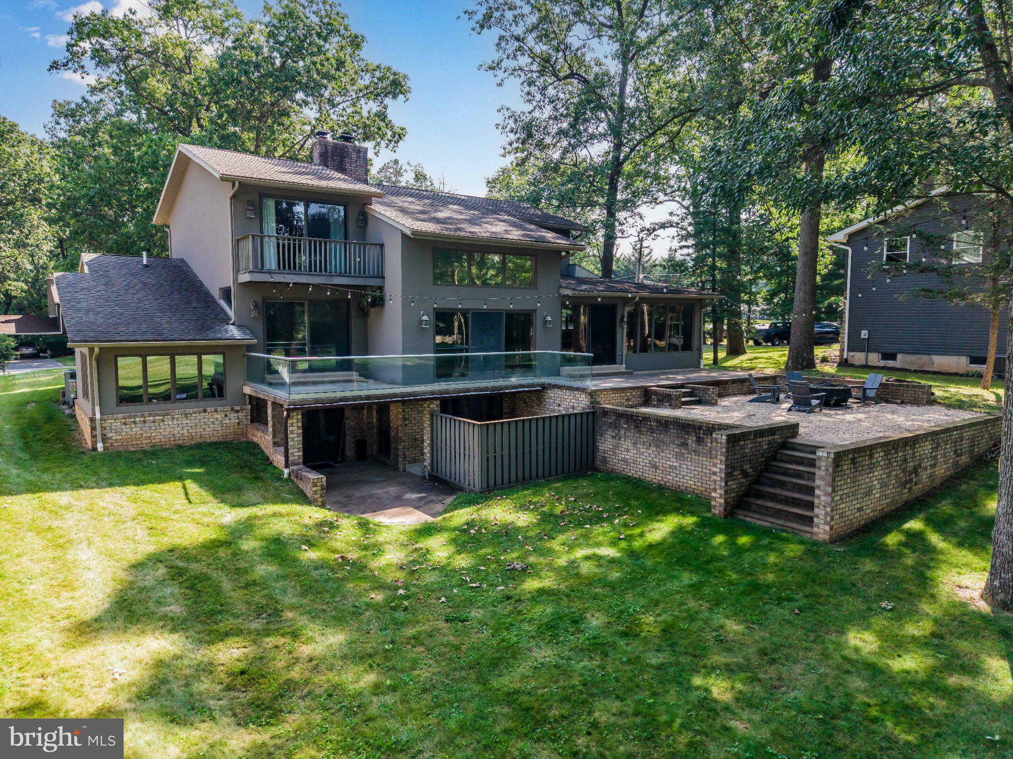 Welcome to 6566 Fairway Drive West, a spacious contemporary home nestled in the sought-after Penn National Golf Course Community, overlooking the 15th hole of the Founders Course.

From the moment you enter, you'll be captivated by serene golf course views, soaring spaces, exposed brick accents, and an open staircase that creates a striking first impression. The sunken living room offers a cozy wood-burning fireplace and ample space for gathering, entertaining, or showcasing room for a grand Christmas tree.

The open-concept kitchen and dining area feature warm wood cabinetry, Corian countertops, abundant storage, and newer appliances, making everyday living and entertaining a pleasure. 

Conveniently located on the main level, the primary suite is designed for comfortable one-level living and includes a sunken den or office, a spacious walk-in closet, and an en suite bath with a private water closet.

Outdoor living is seamlessly integrated throughout the main level, with access to a glass-railed deck and beautifully terraced stone and concrete patios overlooking the course. A laundry room and powder room complete the first floor.

Upstairs, you'll find a loft-style reading nook or home office space, along with two generously sized bedrooms, each featuring its own private en suite bath—ideal for family members or overnight guests.

The fully finished lower level offers exceptional flexibility and is perfectly suited for multigenerational living, an in-law suite, or extended guest accommodations. With both private and interior access, this space includes a full second kitchen, dining area, full bath, and ample room for bedroom and living areas.

Additional highlights include four heat pumps for zoned comfort, updated light fixtures and ceiling fans, electrical improvements, radon mitigation, pull-down attic storage, and an expanded garage storage area.

Located just steps from the clubhouse, Penn National offers 36 holes of championship golf, a seasonal restaurant, outdoor pool, tennis courts, and pickleball facilities. Memberships are available, and many amenities are open to the public. Recognized by Where to Retire magazine as one of America's Top 50 Master-Planned Communities, Penn National offers an exceptional lifestyle in a beautiful setting.

With versatile living spaces, stunning golf course views, and room for everyone, this remarkable property truly has it all. Welcome Home!