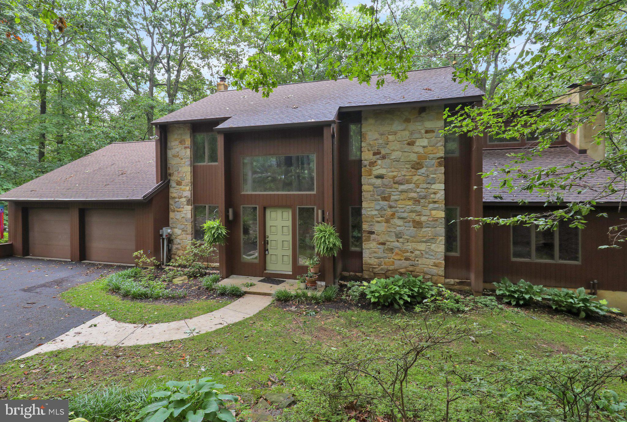 Nestled in a picturesque wooded setting, this beautifully maintained contemporary 4-bedroom, 2.5-bath home offers the perfect combination of modern comfort and natural beauty. Surrounded by mature trees, the property provides exceptional privacy and a peaceful atmosphere while remaining conveniently located near everyday amenities. The spacious interior features an open and inviting floor plan with abundant natural light, generous living spaces, and a cozy fireplace that creates a warm focal point for gathering with family and friends. The well-appointed kitchen flows seamlessly into the main living and dining areas, making entertaining both easy and enjoyable. Upstairs, you'll find four comfortable bedrooms, including a spacious primary suite, along with 2 thoughtfully designed bathrooms to accommodate family and guests. A partially finished basement offers valuable additional living space, perfect for a family room, home office, fitness area, or recreation room, while still providing ample storage.
Step outside to enjoy the home's spectacular natural surroundings. Whether you're relaxing on the deck, hosting outdoor gatherings, or simply taking in the peaceful woodland views, this property offers a tranquil retreat in every season. With its contemporary design, inviting living spaces, and exceptional setting, this home is a wonderful opportunity for those seeking comfort, privacy, and a connection to nature.