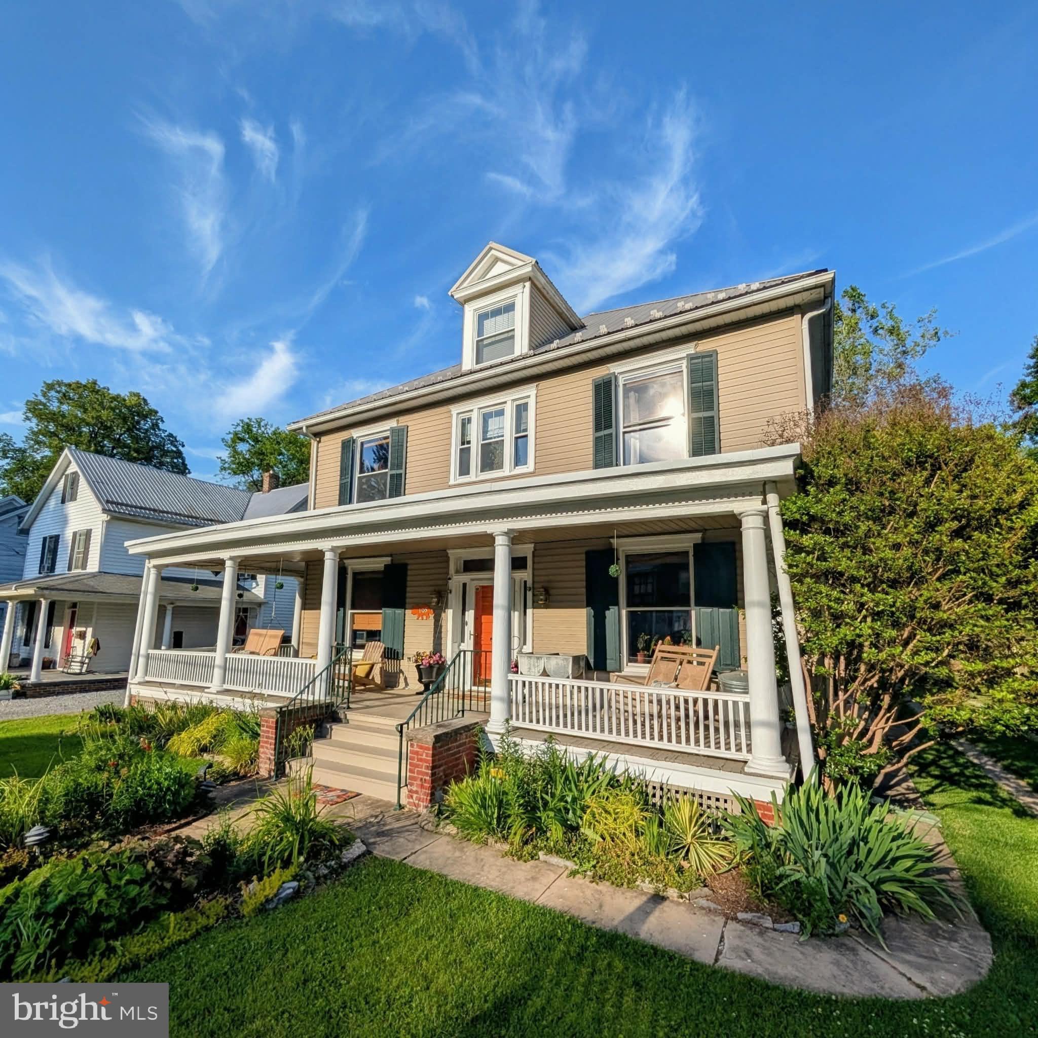 Welcome to 105 Linden Avenue, a historic gem nestled in the heart of Mercersburg Borough. This home, built in 1911, embodies craftsmanship and character that simply cannot be replicated in today’s homes. As you approach, you’re greeted by a sweeping front porch complete with a charming porch swing; perfect for relaxing and enjoying the surroundings. Step inside the home to an inviting entry hall, where a stunning mural hand-painted by former owner Jane Tyson, sets the tone for the home’s unique character. Throughout the first floor, you'll find original maple flooring, crown molding, custom arches, chair rails, and elegant pocket doors that complement the 9 1/2-foot ceilings. Custom-built doors, built-ins, and ceiling fans add to this home’s classic appeal. The chef’s kitchen is a cooks dream, featuring a gorgeous granite island with a striking light fixture, a decorative mantel, granite countertops and custom cherry cabinetry made by local craftsmen with glass-front details. Yellow pine flooring adds warmth, while a subway tile backsplash and exposed beams in the 9 1/2-foot ceiling give the space a rustic charm. Just off the kitchen, the two-story sunroom is a quiet space to watch the changing seasons whether you're enjoying the snowy winter weather or the blooms of spring in your backyard. A full bath with a stand-up shower and tile flooring rounds out the main floor. Upstairs, the staircase is a showpiece in itself, with beautiful quarter-sawn oak steps leading to the second floor. At the top, a cozy window seat invites you to relax and take in your surroundings. The second floor offers four generously-sized bedrooms and two full baths. The first bedroom has been transformed into a functional office, featuring built-in shelving and a refinished wood floor. The primary bedroom, with its beautifully finished wood floors and ceiling fan, opens into a private en-suite bathroom with a luxurious jetted tub. Just outside the primary bath, you'll find the “tree house," a unique feature that was once an exterior porch but has now been seamlessly incorporated into the sunroom below, offering a perfect spot to unwind. The third bedroom is currently used as an at-home gym, while the fourth bedroom serves as a comfortable guest room. The main bathroom on this level boasts a tiled floor, subway-tiled shower, custom chestnut shelves, a built-in medicine cabinet, and charming wainscoting. The expansive attic, with its tongue-and-groove flooring, provides ample storage space, while the unfinished basement is equipped with two natural gas hot water heaters, a 200-amp electrical service, and an updated HVAC unit. Step outside where your backyard oasis awaits. Backing up to the picturesque Mercersburg Inn, the lush grounds are enhanced by over 40 boxwoods that encompass the back yard and a number of colorful azaleas that transform the space each spring, along with a variety of other plants that create your very own 'secret garden.' A two-car detached garage with a loft offers additional storage or a potential workshop. This home is conveniently located just a 2 minute walk to Mercersburg Elementary School,  a 3 minute walk to Mercersburg Academy, a 12-minute drive to Whitetail Ski Resort, and only 10 minutes from Interstate 81. Don’t miss the opportunity to experience the exceptional quality craftsmanship and unique beauty of this historic treasure. Homes like this are truly one of a kind.