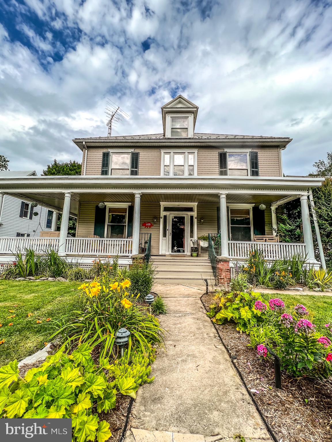 Welcome to 105 Linden Avenue, a historic gem nestled in the heart of Mercersburg Borough. This home, built in 1911, embodies craftsmanship and character that simply cannot be replicated in today’s homes. As you approach, you’re greeted by a sweeping front porch complete with a charming porch swing; perfect for relaxing and enjoying the surroundings. Step inside the home to an inviting entry hall, where a stunning mural hand-painted by former owner Jane Tyson, sets the tone for the home’s unique character. Throughout the first floor, you'll find original maple flooring, crown molding, custom arches, chair rails, and elegant pocket doors that complement the 9 1/2-foot ceilings. Custom-built doors, built-ins, and ceiling fans add to this home’s classic appeal. The chef’s kitchen is a cooks dream, featuring a gorgeous granite island with a striking light fixture, a decorative mantel, granite countertops and custom cherry cabinetry made by local craftsmen with glass-front details. Yellow pine flooring adds warmth, while a subway tile backsplash and exposed beams in the 9 1/2-foot ceiling give the space a rustic charm. Just off the kitchen, the two-story sunroom is a quiet space to watch the changing seasons whether you're enjoying the snowy winter weather or the blooms of spring in your backyard. A full bath with a stand-up shower and tile flooring rounds out the main floor. Upstairs, the staircase is a showpiece in itself, with beautiful quarter-sawn oak steps leading to the second floor. At the top, a cozy window seat invites you to relax and take in your surroundings. The second floor offers four generously-sized bedrooms and two full baths. The first bedroom has been transformed into a functional office, featuring built-in shelving and a refinished wood floor. The primary bedroom, with its beautifully finished wood floors and ceiling fan, opens into a private en-suite bathroom with a luxurious jetted tub. Just outside the primary bath, you'll find the “tree house," a unique feature that was once an exterior porch but has now been seamlessly incorporated into the sunroom below, offering a perfect spot to unwind. The third bedroom is currently used as an at-home gym, while the fourth bedroom serves as a comfortable guest room. The main bathroom on this level boasts a tiled floor, subway-tiled shower, custom chestnut shelves, a built-in medicine cabinet, and charming wainscoting. The expansive attic, with its tongue-and-groove flooring, provides ample storage space, while the unfinished basement is equipped with two natural gas hot water heaters, a 200-amp electrical service, and an updated HVAC unit. Step outside where your backyard oasis awaits. Backing up to the picturesque Mercersburg Inn, the lush grounds are enhanced by over 40 boxwoods that encompass the back yard and a number of colorful azaleas that transform the space each spring, along with a variety of other plants that create your very own 'secret garden.' A two-car detached garage with a loft offers additional storage or a potential workshop. This home is conveniently located just a 2 minute walk to Mercersburg Elementary School,  a 3 minute walk to Mercersburg Academy, a 12-minute drive to Whitetail Ski Resort, and only 10 minutes from Interstate 81. Don’t miss the opportunity to experience the exceptional quality craftsmanship and unique beauty of this historic treasure. Homes like this are truly one of a kind.