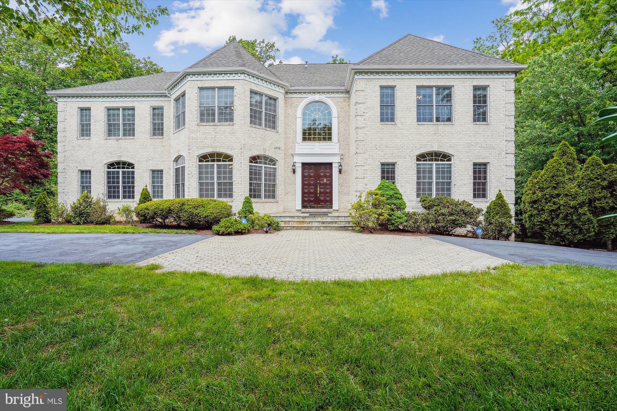 This magnificent custom-built residence nestled in a secluded enclave seamlessly blends classic elegance with modern comfort. Boasting 7 bedrooms, 5 full and 2 half bathrooms spread over 10,000+ square feet, it's an entertainer's dream or a sanctuary of solitude. The home features over 80 Proline Pella windows/doors, smart-wired security, 3 HVAC systems, and a grand 2-story foyer with marble flooring and a curved staircase.

The formal living and dining rooms dazzle with hardwood floors, crown molding, and Palladian windows. A chef's kitchen awaits with top-tier stainless steel appliances, granite countertops, and a sunlit breakfast area. A sunroom overlooks the lush yard, while a 2-story great room offers a gas fireplace and access to a Trex deck.

Upstairs, 4 spacious bedrooms, including a stunning owner's suite with a fireplace and spa-like bathroom, await. The lower level features a recreation room, bar area, media room, and two bedrooms, perfect for guests.

Situated on a private 29,000 sq ft lot, minutes from amenities and major routes, this home is a masterpiece of luxury and convenience. Welcome and enjoy!