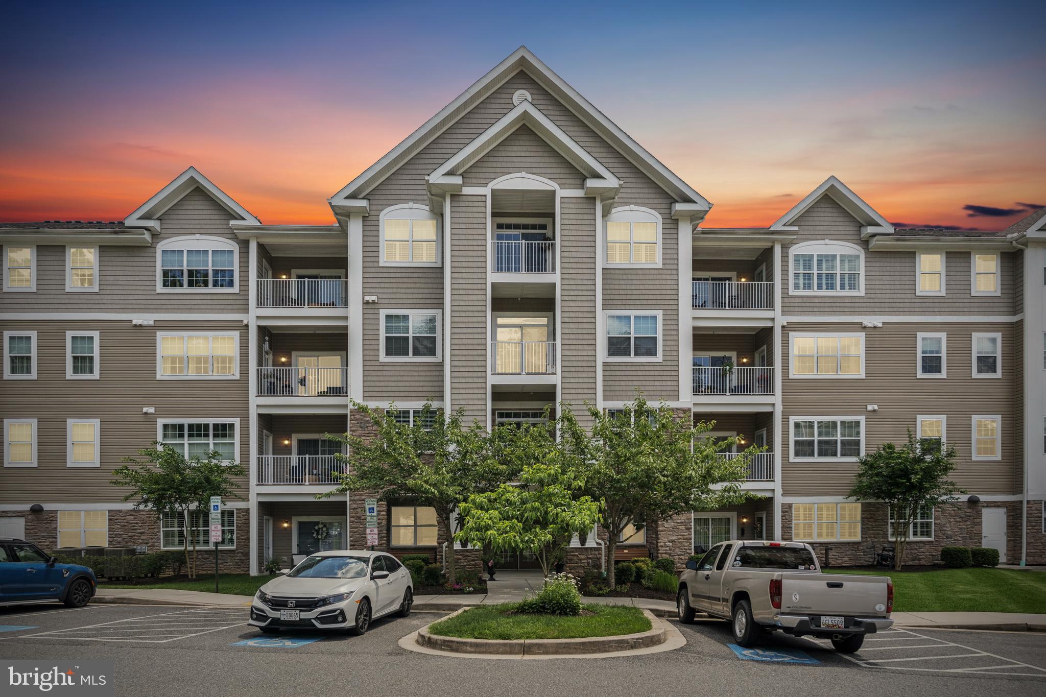 Welcome to 901 MacPhail Woods Crossing, a quiet third-floor condo tucked into one of Bel Air’s most desirable 55+ communities.

This unit checks a lot of boxes…you’ve got elevator access, an assigned parking spot, and one of the best features? It backs to the woods, so your view is nothing but trees and privacy.

Inside, the layout feels open and inviting. The kitchen has tons of cabinet space, stainless steel appliances, and a wraparound breakfast bar that opens right into the living and dining area. It’s great for entertaining or just having a comfortable everyday space. Hardwood floors run throughout the main living areas, and there’s even a fireplace for a cozy touch.

The bedrooms are nicely sized, with the primary suite offering a walk-in closet and a large bathroom with double sinks and a walk-in shower. There’s also a second full bath and a laundry room with a full-size washer and dryer.

One of the best parts? Step out onto your private balcony and you’re surrounded by trees,it’s peaceful, quiet, and a perfect spot for your morning coffee.

This is low-maintenance living in a well-kept elevator building, just minutes from shops, restaurants, and everything you need in Bel Air.