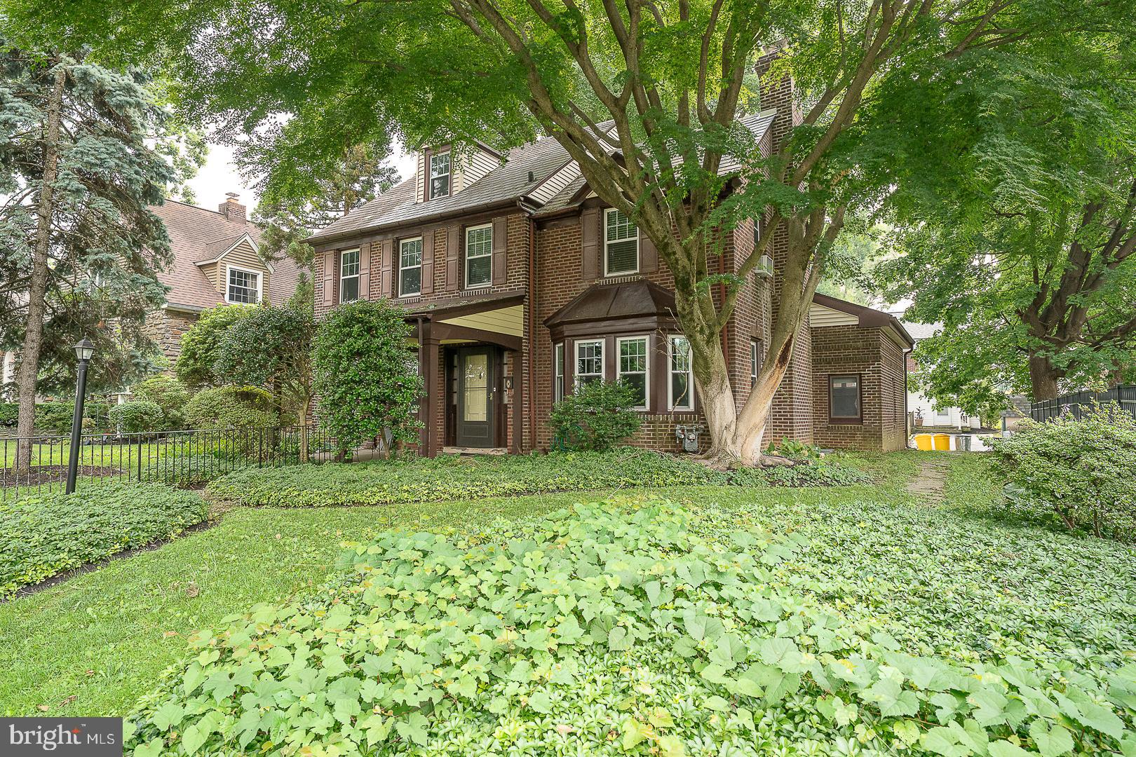 Welcome to 52 Rock Glen Road, a beautifully maintained 5-bedroom, 4-full-bathroom center hall Colonial offering 2,232 square feet of flexible living space in the award-winning Lower Merion School District. A charming covered front porch sets the tone, welcoming you into a classic home that blends timeless character with modern updates. The spacious living room features gleaming hardwood floors, crown molding, custom built-ins, and a cozy wood-burning fireplace, creating the perfect setting for relaxing or entertaining. The formal dining room, accented with chair rail and crown molding, flows seamlessly into the updated eat-in kitchen, complete with granite countertops, stainless steel appliances, abundant cabinetry, and a bright breakfast area. A door from the kitchen leads to the rear patio and level backyard, offering an ideal space for outdoor dining, play, or gardening.

The first-floor primary suite offers exceptional flexibility, with a walk-in closet, a full ensuite bathroom, and a private exterior entrance, making it an ideal in-law suite, guest quarters, or private home office. Upstairs, the second floor features two generously sized bedrooms connected by a Jack-and-Jill bathroom with a tub, an additional bedroom, and a full hall bathroom. The third floor offers a private fifth bedroom and full bathroom, perfect for guests, teens, or an additional home office. The unfinished basement includes a laundry area, abundant storage, and excellent potential for future finished living space.

Ideally located just minutes from shopping, dining, parks, major roadways, and public transportation, this home offers an easy commute to Center City Philadelphia while providing the charm and convenience of one of the Main Line's most desirable neighborhoods. A rare opportunity to own a spacious, versatile Colonial in an exceptional location.