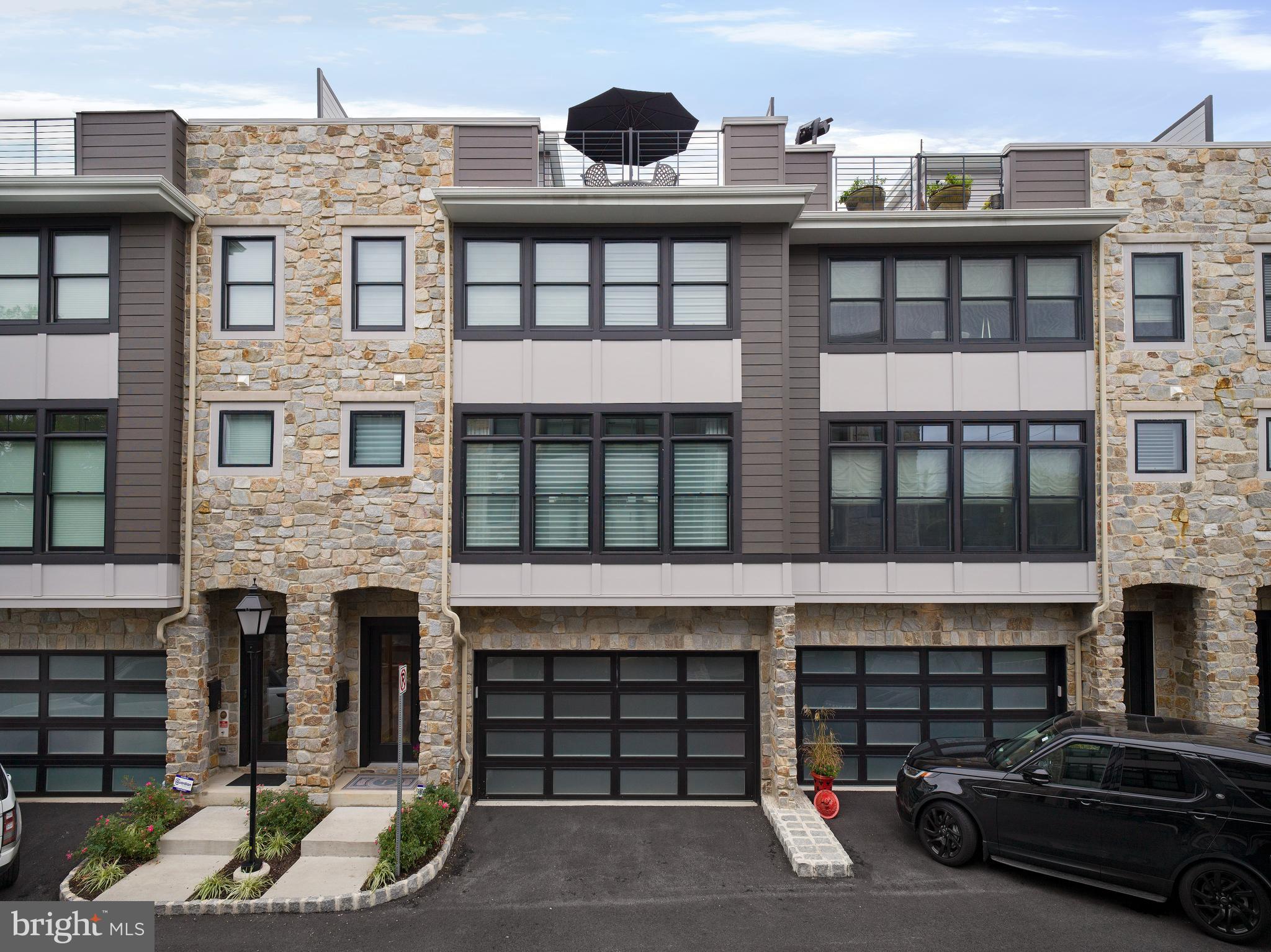 Seize the chance to own a stunning 3,400 sq ft luxury townhome in the highly sought-after community of The Brownstones at Berkley, where only 7 limited residences have been built.

Upon entering the home, you're greeted by a welcoming foyer leading to a spacious flex room, currently styled as a bedroom with a full bathroom, along with convenient access to the 2-car garage and a mudroom.

The main living level is an entertainer’s dream, boasting soaring 10' ceilings, a seamless open floor plan, and an expansive great room with oversized windows featuring custom window treatments. A gas linear fireplace with custom built-ins adds warmth and elegance.

The gourmet kitchen is every chef's delight. It features custom cabinetry, an impressive 12-foot double-sided island for ample storage and entertaining, upgraded quartz countertops, JennAir stainless steel appliances, and stunning custom lighting. Opposite the kitchen, you’ll find a pantry and a sleek wet bar – perfect for hosting gatherings. The adjacent dining area is spacious enough for large dinner parties. Just a few steps up and tucked discreetly away is a beautifully appointed powder room, complete with custom cabinetry and extra storage.

On the upper level, the primary bedroom suite offers the perfect retreat, complete with space for a king-size bed, a spacious custom closet with a vanity area, and a luxurious en-suite bathroom featuring a large double-sink vanity, walk-in shower with frameless glass doors, custom tile, and a separate water closet. Down the hall are two generously sized bedrooms, each featuring custom closets, a well-appointed hall bathroom, and a dedicated laundry room.

The fourth-floor loft adds extra living space, ideal as a TV room, home office, or additional bedroom. A half bath and a custom outfitted closet complete the loft space. The crown jewel of the home is the expansive private rooftop terrace, perfect for sunset gatherings, complete with an outdoor kitchen to enjoy luxurious outdoor living.

This exquisite townhome also features a 4-stop elevator providing easy access to every level and ample storage throughout. Custom closets and custom window treatments are found throughout the entire home, offering both style and convenience.

In addition to its luxurious amenities, the home boasts exceptional walkability to local shops, restaurants, the R-5 train line, and the famous Devon Horse Show.

Don’t miss the opportunity to experience sophisticated living in this remarkable community.