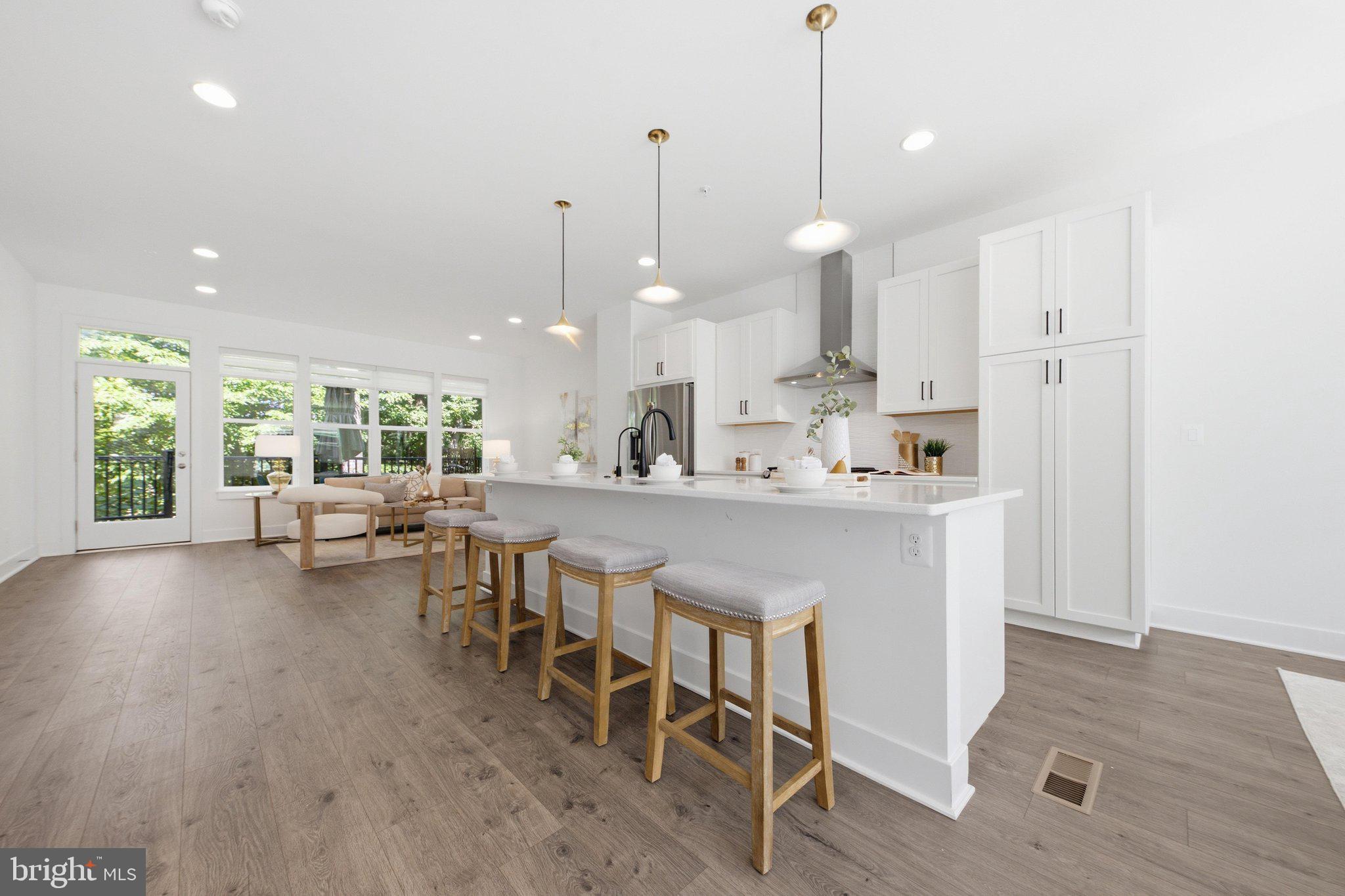 Welcome to this exceptional four-level luxury townhome with a private elevator, rooftop terrace, and spectacular golf course views—a rare offering in the heart of the City of Fairfax. This stunning contemporary residence blends modern sophistication with refined comfort, featuring 4 bedrooms, 3 full baths, and 2 half baths across four thoughtfully designed elevator-accessible levels with exceptional attention to detail.  The bright, open-concept main level showcases wide-plank hardwood flooring, soaring ceilings, and seamless living and dining spaces designed for both everyday living and effortless entertaining. The gourmet kitchen features sleek quartz countertops, stainless steel appliances, contemporary cabinetry, and a large center island. Just beyond the family room, the spacious deck overlooks the Army Navy Country Club golf course, providing a peaceful setting for morning coffee, outdoor dining, or simply enjoying the scenic views. Residents also enjoy convenient access to Daniels Run Park via nearby trails.  The upper bedroom level features a spacious primary suite, two additional bedrooms, and a full hall bath, providing an ideal layout for family living. The top level offers a private bedroom suite that opens to an expansive rooftop terrace with breathtaking golf course views—an exceptional outdoor retreat perfect for relaxing, entertaining, or enjoying sunsets under the stars. 
The entry level includes a versatile recreation room with a convenient half bath, making it an ideal space for a home office, media room, fitness area, or guest retreat.   Built with modern energy-efficient features, this home also includes a two-car garage and beautifully landscaped community spaces, offering the perfect blend of luxury, comfort, convenience, and low-maintenance living.   Ideally located on the eastern edge of Fairfax City, Sutton Heights is just minutes from the Vienna Metro, I-495, I-66, Tysons, the Mosaic District, and Inova Fairfax Hospital. A wide variety of shopping, dining, parks, and everyday conveniences are nearby. OPEN SUNDAY July 12th  1-4pm