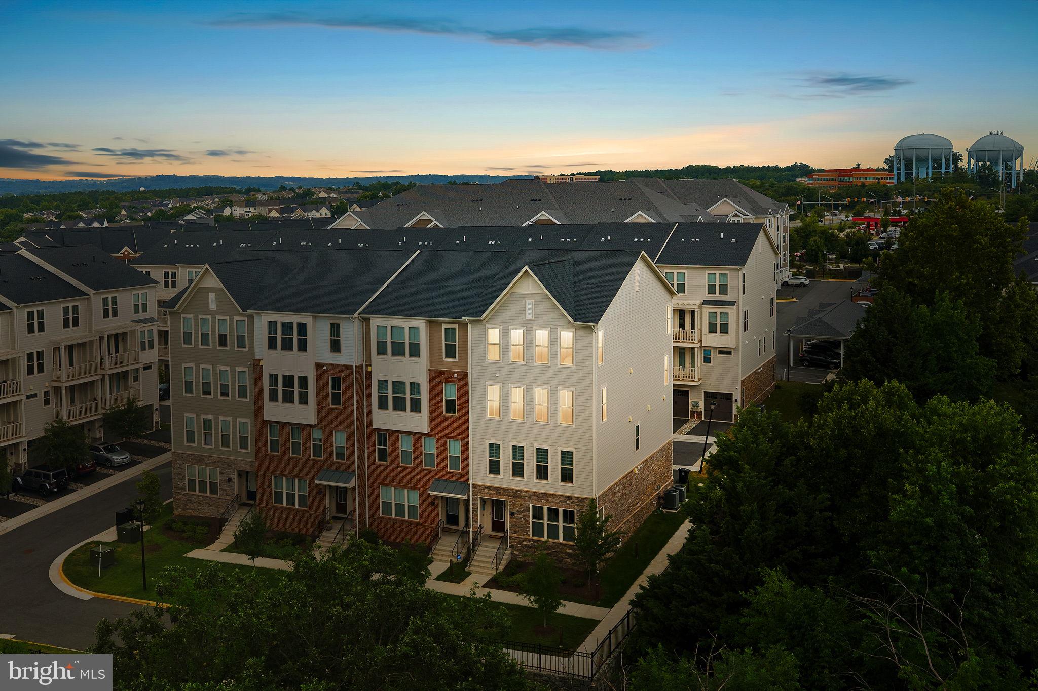 Why wait for new construction when you can have a nearly new home with upgrades already complete? Built in 2023, this upgraded and spacious Potomac Station Marketplace condo offers over 2,600 square feet of beautifully designed living space, 3 bedrooms, 2.5 baths, an exceptionally low condo fee, and the potential for a qualified buyer to assume the seller's VA loan with an attractive 4.99% interest rate. Opportunity awaits! 

The open floor plan is designed for both everyday living and entertaining, featuring a gourmet kitchen with upgraded cabinetry & countertops, stainless steel appliances, and an oversized walk-in pantry. A dedicated main-level office provides the perfect work-from-home space, while the expansive living room with cozy electric fireplace offers unbeatable views. 

Upstairs, the generous primary suite features an upgraded ensuite bath, along with two additional bedrooms and a full hall bath. An attached one-car garage and abundant community parking add to the home's convenience.

Located in the heart of Potomac Station Marketplace, you'll enjoy easy access to the Leesburg Premium Outlets, grocery stores, restaurants, and major commuter routes. With modern construction, over 2,600 square feet of living space, remarkably low condo fees, and potential financing advantages that are difficult to find in today's market, this home offers exceptional value.