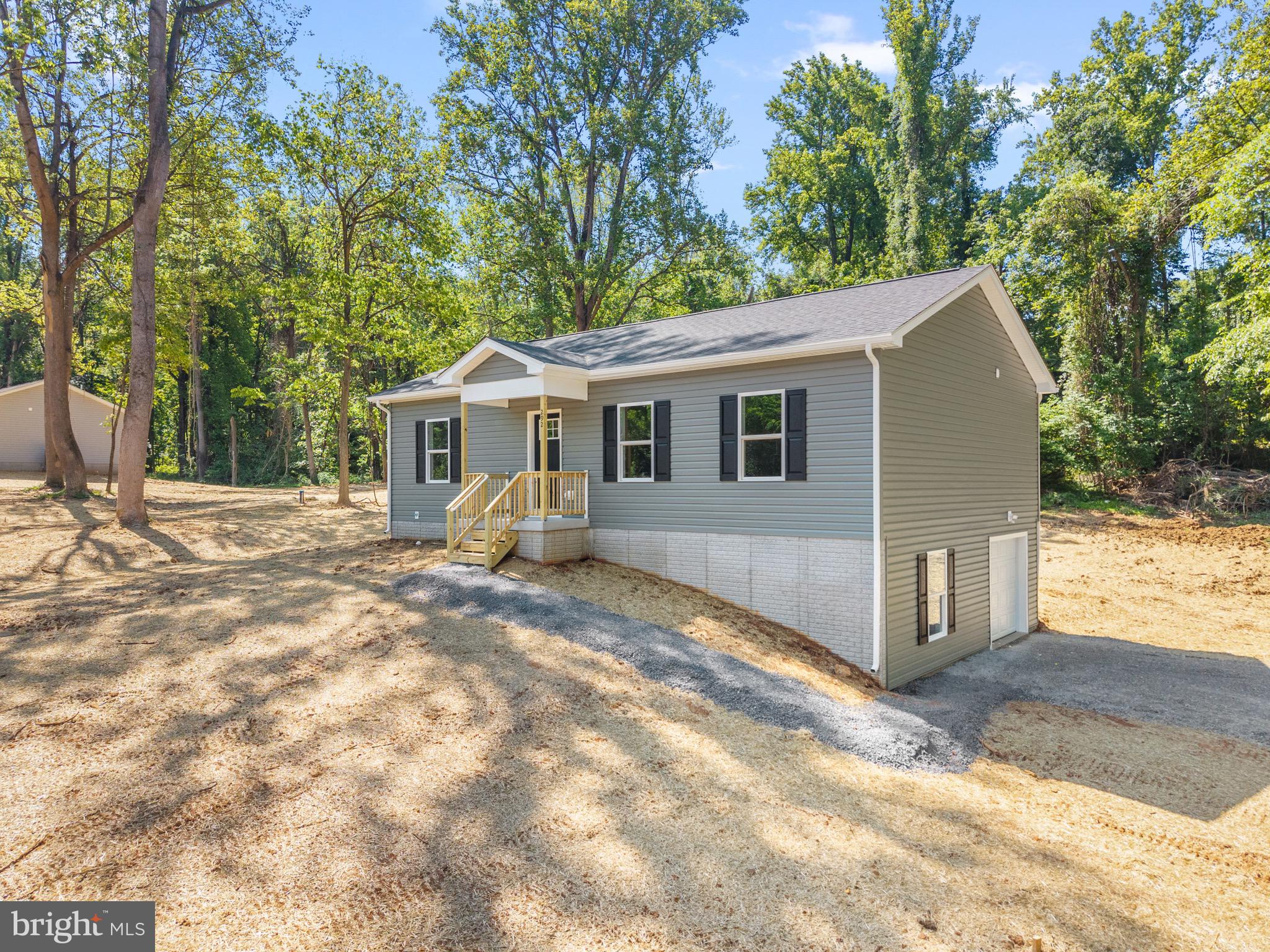 Brand-new construction situated on 1.5 wooded acres in the desirable community of John Brown Farm with deeded Shenandoah River access. This thoughtfully designed ranch-style home offers convenient main-level living with an open-concept layout featuring a spacious living room, dining area, and kitchen with center island. Durable luxury vinyl plank flooring runs throughout the home, offering a cohesive look with easy maintenance and no carpet. Just off the kitchen, you’ll find a dedicated main-level laundry room for added everyday convenience.
