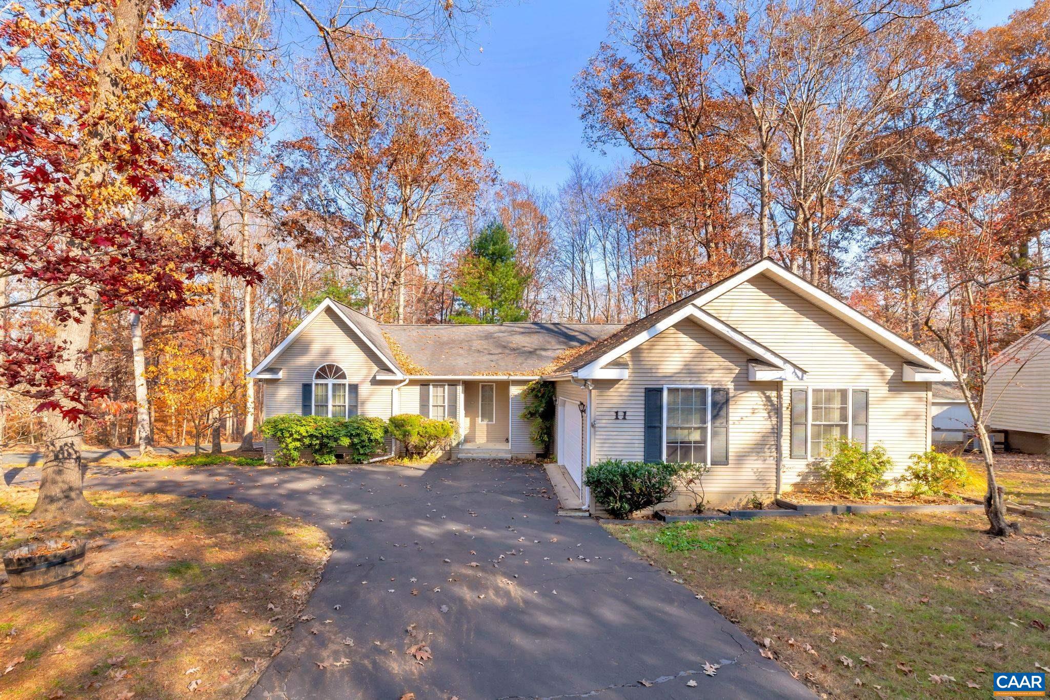 THIS VAULTED RANCHER IS THE EPITOME OF COMFORT & STYLE?ALL WITHIN A 2-BLOCK WALK TO BEACH?Spacious Living Room w/Hardwoods--Gas FP with 2 Doors that lead out to New Trex Deck & Fenced Backyard.  Included in Home?s Design is an Open & Bright Eat-in Kitchen w/Breakfast Bar & SS Appl. Including Gas Range, Built-in Glass-Front China Cabinets & Side Serving Buffet, Arched Doorways, Central Vac, Vaulted Owner?s Suite w/2 Walk-ins, Vaulted Guest BRs, Relaxing Sunroom w/Paladin Window Looking Out To Fenced Backyard ?Offering Picturesque View of Natural Surroundings! Plus, Encapsulated Crawl, Oversized Garage w/Storage Rm, & Corner Homesite w/paved Circular Drive. HOME'S INTERIOR FRESHLY REPAINTED!,Glass Front Cabinets,Wood Cabinets,Fireplace in Living Room