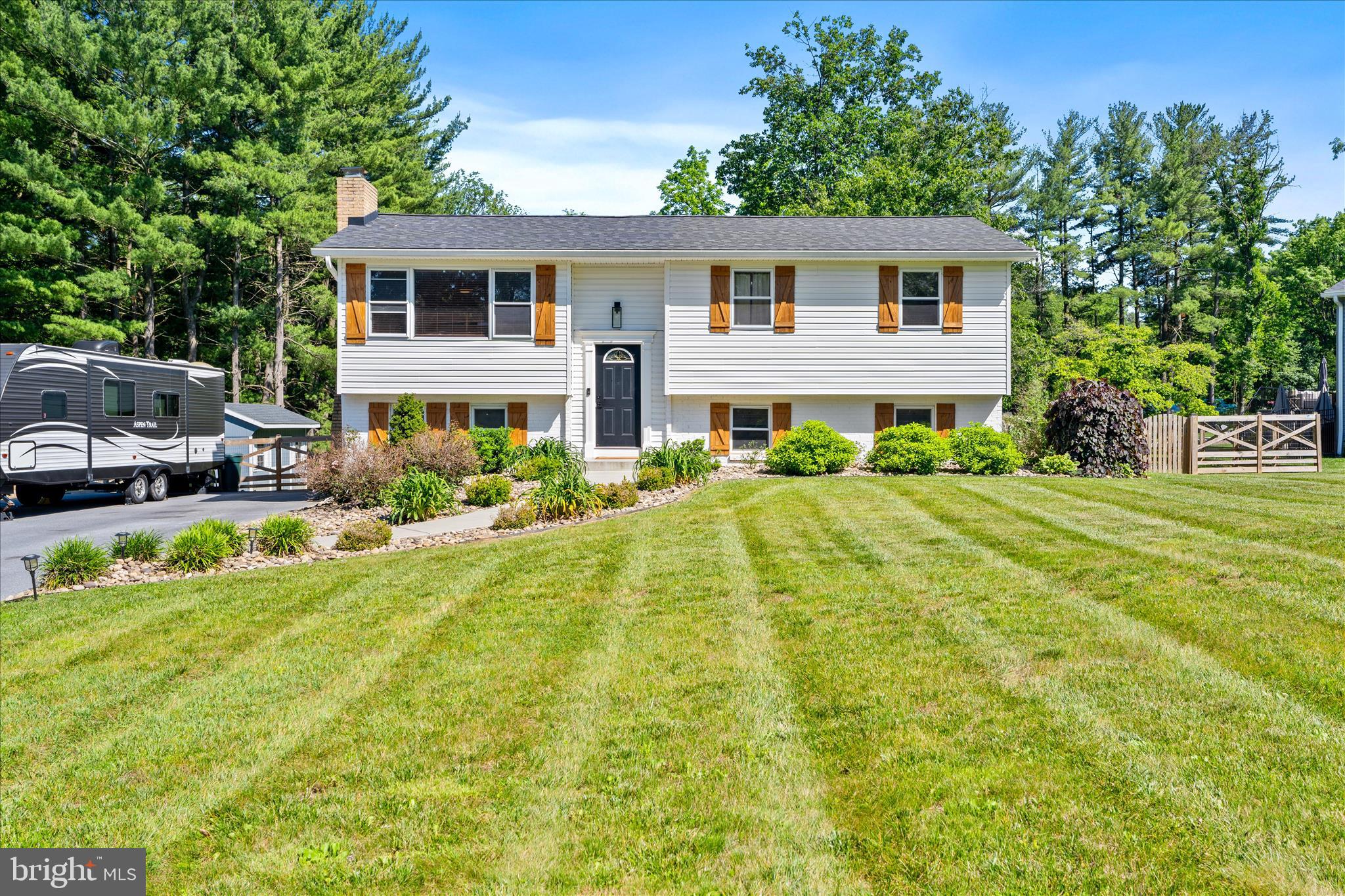 SMITHSBURG SCHOOLS. Check out this completely updated home with a serene lot on a quiet neighborhood street.  After a full remodel in 2022 this house is completely turn key with upgraded kitchen cabinets, new appliances, luxurious countertops, and a new roof.  This home has been beautifully styled with and includes additional storage for functional living.  The main level offers an open feel from the living room with the built in electric fireplace and bonus bar area as it leads to the large kitchen.  The bonus room behind the kitchen offers more living space or an office setting that leads out to the deck.  Updated bathrooms and large bedrooms make this home an option for a group of any size.  The exterior really shines with a recently added fence and a large storage shed.  Enjoy the space with a deck, a patio, and a custom pergola.  This the perfect location to escape and relax but still have easy access to shopping, dining, and major commuter routes.