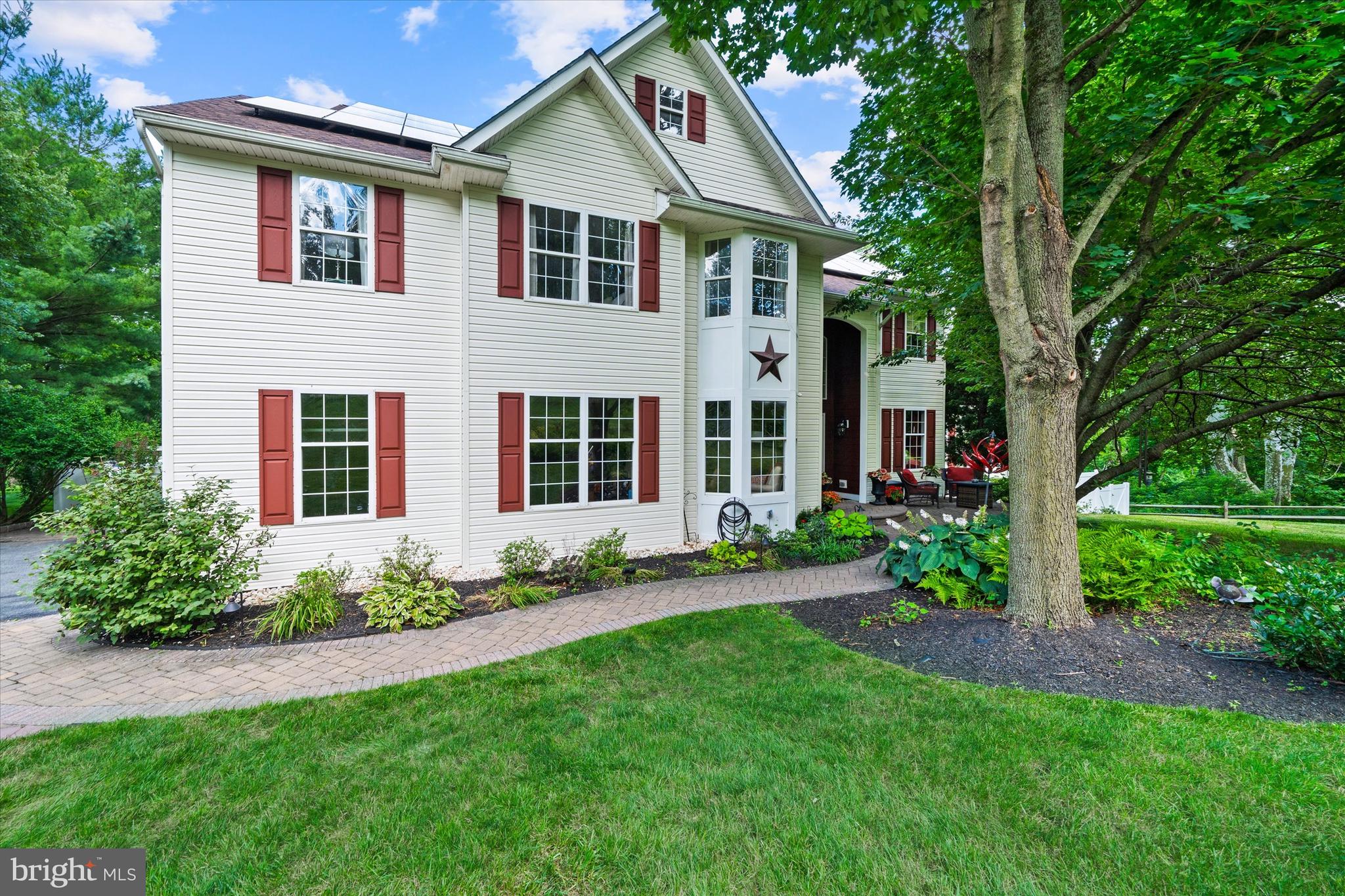 Welcome to this exceptional home in the award-winning Avon Grove School District, perfectly situated on a picturesque 0.92-acre lot that backs to a serene nature preserve and animal sanctuary. Nestled among mature trees and surrounded by professionally designed landscaping and hardscaping, this property offers privacy, tranquility, and an outdoor lifestyle that is truly second to none. The spectacular backyard is the undeniable centerpiece of this home—a private resort designed for unforgettable entertaining and everyday relaxation. Enjoy summers with an in-ground pool, gather with family and friends on the expansive partially covered paver patio and pool deck, or unwind in the hot tub. The fully fenced backyard creates a secluded retreat where every detail has been thoughtfully planned to maximize both beauty and function. Inside, the home blends spacious living areas with numerous modern updates. The beautifully appointed kitchen features an oversized center island with beverage minifridge, granite countertops, tile flooring, a stylish tile backsplash, and a dedicated coffee or wine bar complete with a new wine refrigerator. A suite of newer GE Profile appliances makes this kitchen as functional as it is inviting. Flowing seamlessly from the kitchen is the dramatic two-story family room, highlighted by a cozy wood-burning fireplace and a stunning wall of windows that frame breathtaking views of the backyard oasis. The main level also offers formal living and dining rooms, a bright sunroom ideal for entertaining or relaxing, and a private home office tucked away off the foyer. A convenient main-floor laundry room and an attached garage featuring a durable epoxy-coated floor complete the first level. Upstairs, you'll find four generously sized bedrooms, including a spacious primary suite featuring two walk-in closets, sitting area and a luxurious en-suite bath with a soaking tub, separate shower, and dual vanities. Designed with entertaining in mind, the finished walkout lower level extends your living space with a spacious game room, media room, and flexible recreation area for fitness or additional gathering space. Abundant windows fill the lower level with natural light while providing direct access to the covered patio and pool area, creating seamless indoor-outdoor living. Recent improvements provide exceptional value and peace of mind, including a new roof with leased solar panels, EV charger, new Hardie Board siding on the front exterior, new fencing, new carpeting, and luxury vinyl plank flooring throughout the main living areas and the primary bedroom. The custom-designed pool was re-plastered and received new coping in 2014, ensuring years of enjoyment. Located in one of the area's most desirable neighborhoods with no HOA, this exceptional property offers the perfect blend of privacy, luxury, and convenience providing more than just a home, it's a lifestyle. Experience peaceful country living while enjoying easy access to everything Chester County has to offer. You're less than 10 minutes from the charming boutiques, restaurants, cafés, and year-round events of Kennett Square, world-renowned Longwood Gardens, and tax-free shopping in Delaware, with West Chester just a short drive away. Convenient access to major commuting routes makes traveling throughout the region effortless. As an added bonus, the seller is including an American Home Shield Basic Home Warranty, offering additional peace of mind for the new owner. Don't miss this amazing opportunity!