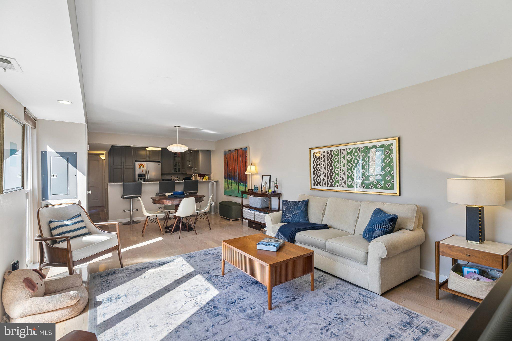 Bright and beautifully appointed bi-level condominium in the highly sought-after Penn’s Landing Square community in Society Hill, offering a seamless blend of modern design, light-filled interiors, and exceptional private outdoor living.
Nestled within lushly landscaped courtyards and a tranquil, garden-style setting, the home is introduced through a private entry and foyer before ascending to an expansive open-concept living and dining level. Rich flooring, recessed lighting, and oversized windows frame serene courtyard and pool views with a dramatic city skyline backdrop, creating an airy yet refined main living space well-suited for both everyday living and entertaining.
The stainless steel kitchen is thoughtfully designed with gray cabinetry, marble countertops, and a crisp white subway tile backsplash. Unlike many residences in the community, this kitchen is fully open to the dining area and includes a breakfast counter, enhancing flow and functionality while creating a true social layout. A conveniently located powder room completes this level.
Upstairs, the primary suite offers a bright and generously scaled retreat, easily accommodating a king-sized bed along with a sitting or reading area. The updated bathroom features a clean, modern aesthetic with a sleek white vanity and a separate bath and shower layout for added comfort and privacy. A hallway laundry closet with stacked washer and dryer adds everyday convenience to the bedroom level.
The second bedroom is exceptionally spacious and opens through sliding glass doors to a private deck—an outstanding outdoor extension of the home. This rare retreat includes skyline views, a covered storage area, and ample space for dining, lounging, or enjoying morning coffee and summer fireworks.
Residents of Penn’s Landing Square enjoy a quiet, gated community atmosphere with a recently renovated swimming pool, beautifully maintained grounds, and a true sense of urban oasis living. Just moments away is the historic and highly walkable Old City district, known for its vibrant dining scene, independent art galleries, and cultural energy, along with waterfront recreation along the Delaware River Trail.
Nearby highlights include acclaimed restaurants such as Zahav and Bloomsday, as well as Headhouse Square Farmers Market and the broader Society Hill historic district.
Blending privacy, convenience, and lifestyle amenities in one of Society Hill’s most distinctive communities, this home offers an elevated city living experience with rare outdoor space, resort-style surroundings, and Garage Parking.