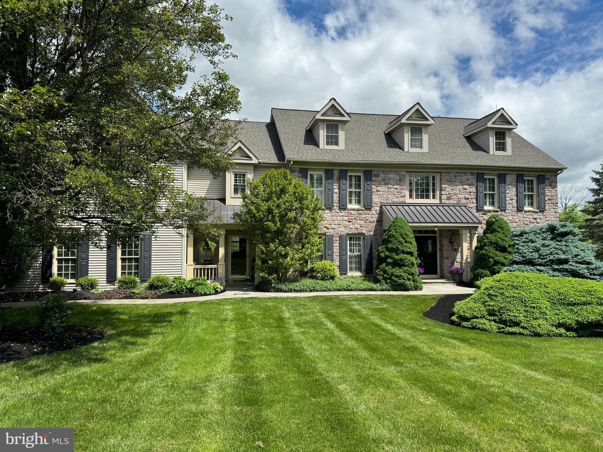 Custom built stone front farmhouse built by respected Bucks County builder David J. Schrenk located on 2.29 acres overlooking beautiful Bucks County countryside!; this cul-de-sac street is part of the small enclave of homes which make up the Mallard Pond Development that includes a large scenic pond with two resident swans which adds to a magical feeling! The home includes 7 bedrooms, 5 full baths and 2 half baths as well as a 3 car side entry garage; a Bluestone walkway meanders to the 2 story formal entry foyer which is accented by a gorgeous turned staircase and transom window features to each adjoining room along with a custom medallion in the hardwood flooring; a separate common entry with covered front porch has a second stairway and access to powder room, laundry room and the garages as well as the sitting area in the kitchen;  a formal dining room and living room are found just off of the formal entry; the family room has a soaring cathedral ceiling with accent beams, a floor-to-ceiling stone fireplace and a second floor hallway overlook; the beautiful remodeled kitchen is sure to please with huge island and large sitting area and a cathedral ceiling  dining area with stone gas fireplace, Palladian style windows and access to one of three decks; a first floor office with deck, a second powder room and laundry room complete the first level; 
the main bedroom features a large sitting room, a tray ceiling main room, two walk-in closets and a magnificent main bath; 4 additional bedrooms and two additional full baths complete this level; the top level includes a full bath and two very large potential bedrooms (or ideal for a nanny suite); the finished basement is an entertainers delight featuring a billiards room, a media room, a multi purpose room, a 1950's barn themed bar with sink and built in microwave and a large storage area and utility room;  the rear yard is spectacular! -  An inviting paver patio with hook up for outdoor television  and the heated, built in pool with sliding board, stone landscaping and luxurious stone cabana with fireplace, grill and a separate firepit for toasting marshmallows or just to keep warm on cold starry nights; other features include custom trim work and moldings throughout; this home is truly a classic and could not be reproduced at twice the price! Check out the videos - especially outside drone footage a couple summers ago