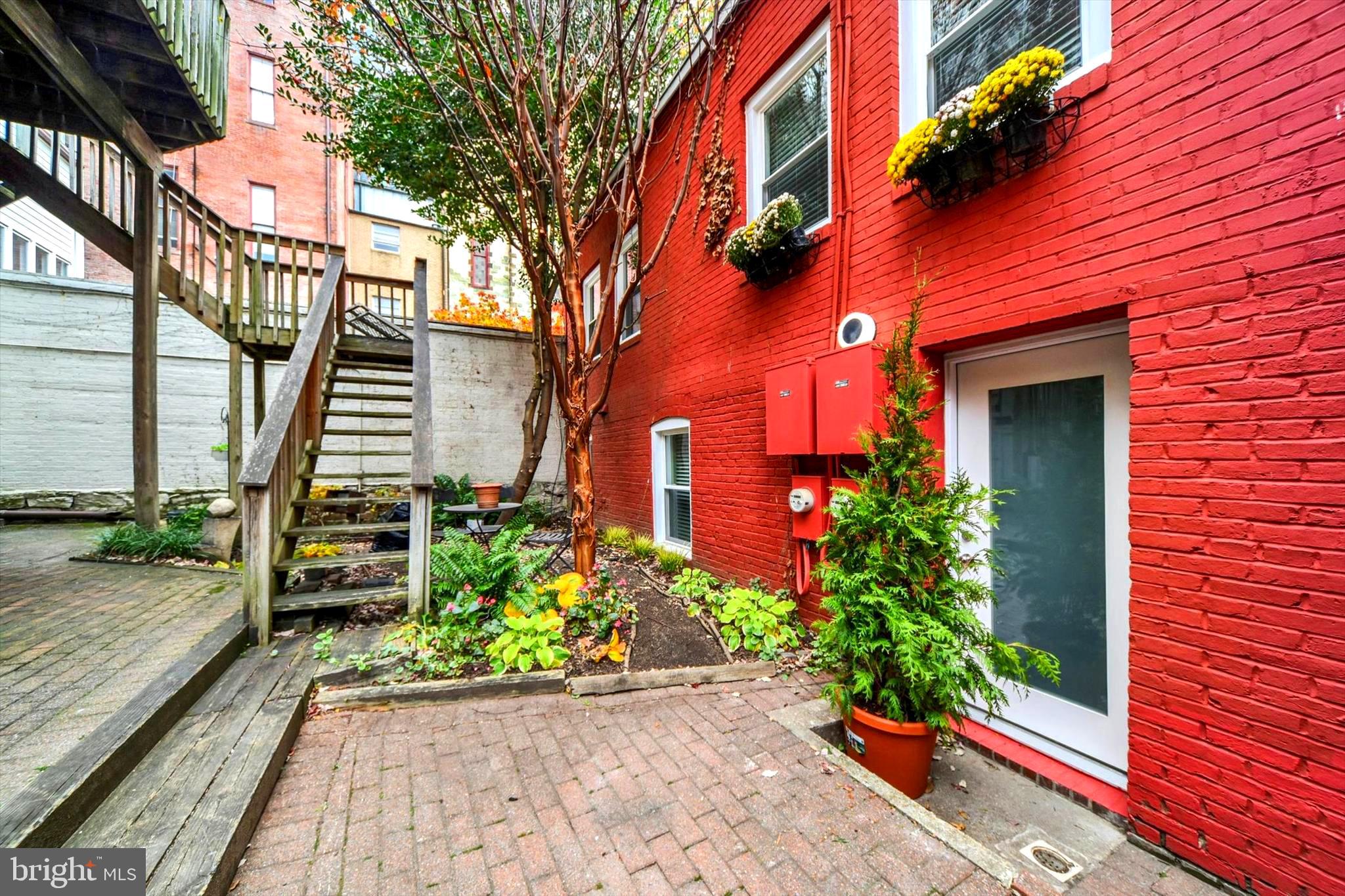 A hidden gem in the heart of Mount Vernon. Quite literally tucked away like a secret garden, this one-of-a-kind historic carriage house is hidden inside a picturesque shared courtyard that most people would never know exists. Offering the perfect blend of timeless character and modern updates, this beautifully renovated two-level, 2-bedroom, 1.5-bath condo feels like a private retreat while placing you in the center of one of Baltimore's most iconic neighborhoods.

Inside, you'll find a stunning new kitchen, open-concept living space with original hardwood floors and exposed brick facade, a convenient main-level powder room, and two very spacious upstairs bedrooms with an beautifully update full bath with custom tile work. Skylights flood the home with natural light, while recent improvements—including a new HVAC system, updated electrical, new windows, and new doors—provide true move-in-ready peace of mind.

Enjoy low-maintenance living with condominium services that include exterior maintenance, landscaping, snow and trash removal, water, elevator service, secure entry, package delivery, private storage, dedicated green space, and beautifully maintained shared courtyards. Just beyond your front door, you're moments from the Washington Monument, the Peabody Library, Walters Art Museum, world-class restaurants, coffee shops, theaters, cultural attractions, Penn Station, and major commuter routes—making this a rare opportunity to own a truly special home in the heart of historic Mount Vernon.