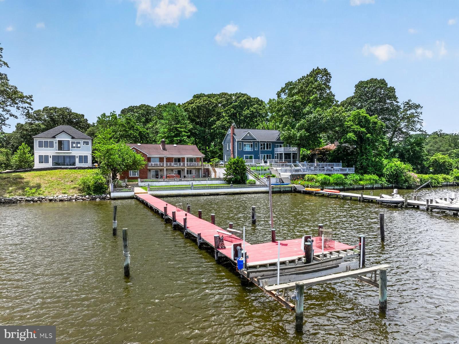 Welcome to this impressive 4,300-square-foot waterfront residence located on the scenic Little Magothy River, renowned among the 105 homes here as Annapolis's best-kept secret. This elegant home offers five bedrooms and three full bathrooms, designed to accommodate comfort and luxury.

Enjoy expansive water views and effortless access to the Chesapeake Bay, making this an ideal property for boating enthusiasts. The private 110-foot pier is equipped with electricity featuring a full slip and a boat lift, 5' depth, MLW as well as a sandy beach and a safe harbor for protection during storms.

The spacious yard is perfect for hosting large gatherings, yet requires minimal maintenance. Outdoor amenities include a shuffleboard court, hot tub, and ample space for either a large or small firepit.

While the home is well-maintained, it offers a unique opportunity for customization, allowing you to update and personalize the interior to your taste. The flooring consists of hardwood and tile, complemented by luxury vinyl in the lower level bedroom, the living area off that bedroom and the hallway, currently no flooring is there. See agent notes.

Additionally, the lower level includes a bedroom and bathroom with a private entrance, ideal for multigenerational living or guest accommodations.