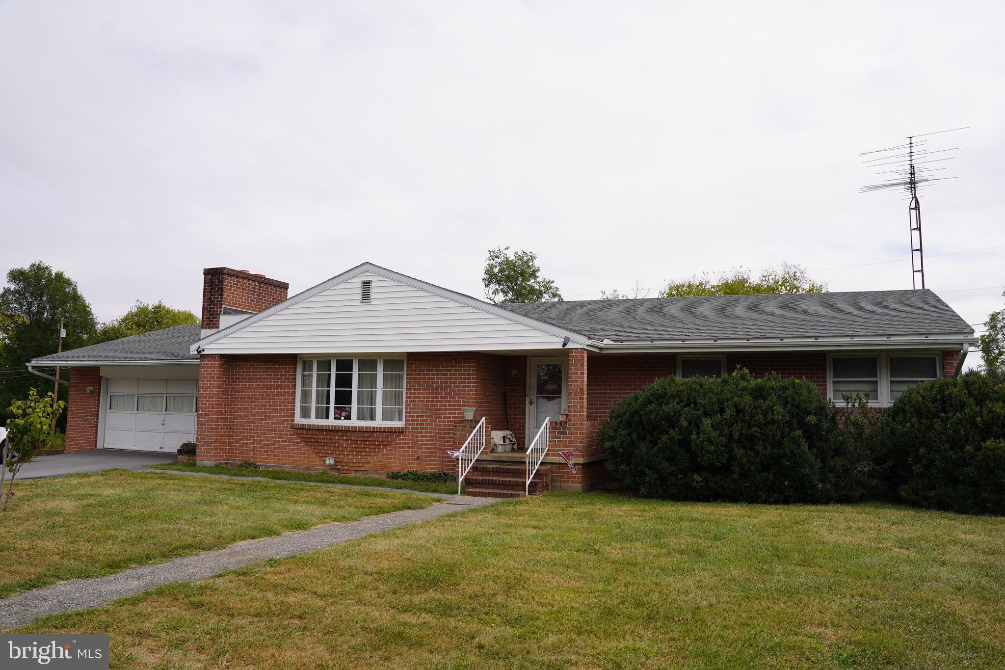 Built in 1965, this brick ranch offers mid-century character on two lots totaling approximately 0.48 acres. The main level features 3 bedrooms, 1.5 baths, and approximately 1,515 sq ft, including a living area with two fireplaces. The kitchen includes a double oven for convenient meal prep. Home is serviced by a heat pump with central A/C. An attached 2-car front-entry garage, driveway parking, and a partially finished basement with exterior entrance provide added flexibility. Convenient access to area amenities and commuter routes.
