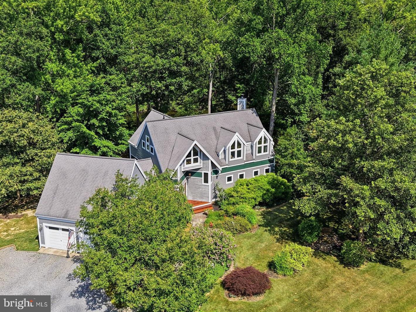 Custom-built home in Country Club Estates with beautiful architectural details. Spacious open living space with hardwood floors and wooden beams, glowing with ample natural light! Enjoy time on the large screened porch, finished with Ipe hardwood, overlooking the peaceful creek,  woods and park like setting. 
Five bedrooms and 4 full bathrooms, nicely designed with privacy in mind. There's an entry-level bedroom and full bathroom. The partially finished basement offers a large bedroom or bonus room, a full bathroom, and an oversized workshop space. 
Upstairs you'll find two bedrooms that share a full bathroom, as well as the primary bedroom, which is nicely situated with a view of the creek/pond.
Enjoy peaceful views of the creek from the slate patio, and launch a kayak to explore the water from your backyard. 
This property leaves little to be desired! Two-car garage, peaceful water view, cozy fireplace, large living space, nicely landscaped, and a hot tub! 
Under 2 miles from downtown Chestertown and a short stroll to the Chester River Yacht & Country Club.