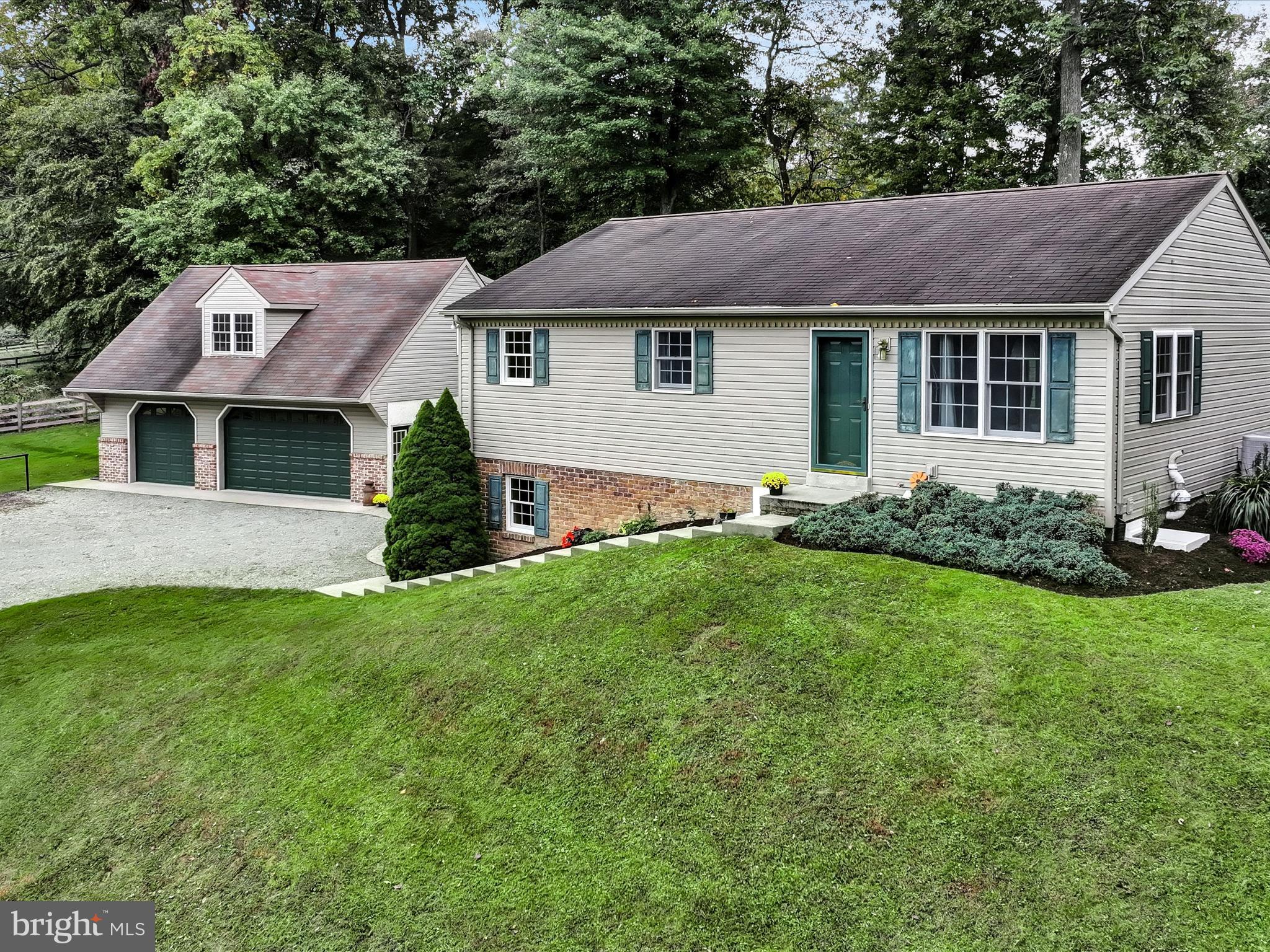 Nestled in the peaceful countryside of Peach Bottom, this charming 5-bedroom, 2-bathroom home offers both space and comfort. The property features a large secondary living area, perfect for gatherings or additional living space. Recent updates include brand-new windows in the living room, downstairs bedrooms, and bathroom . Sitting on over 2.8 acres, this partially wooded lot also includes an oversized 3 car garage with an unfinished space above it with loads of potential, accessible by a private entrance.  With a fenced-in pasture and run-in shed, this property offers endless potential for those seeking a quiet, rural lifestyle. Don't miss out on this unique opportunity in the Solanco School District!