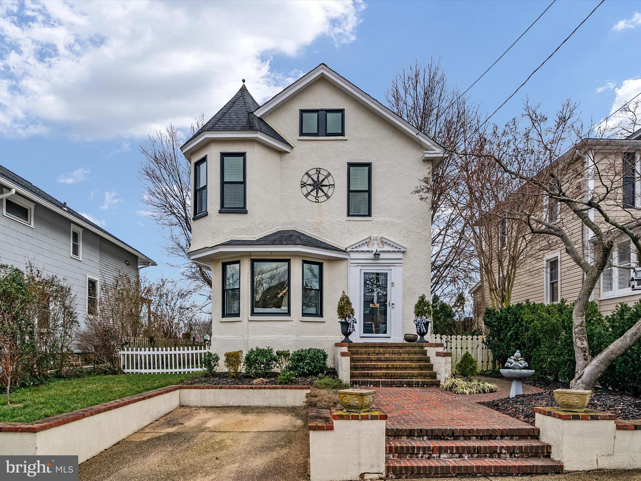 Charming Victorian home in Murray Hill neighborhood, ideally located just a block from  the Annapolis Arts District and down the street from water taxi access on Spa Creek. This historic stucco home is filled with natural light and has 9' ceilings, original hardwoods, fenced back yard, and parking pad.  Seller has made many recent improvements including a huge walk-in primary closet with custom shelving and barn door; gas fireplace with custom mantle, shiplap, tile, and lighted shelving; recessed and adjustable lighting throughout; kitchen quartz counters  (2023); new windows (2023); newer roof  (2017); renovated full baths on each floor (2018 and 2020).  An enclosed porch off the primary could be converted to a spacious en-suite primary bath, and the first-floor den can be used as a main-level 4th bedroom or guest suite. This tastefully updated, well-located home has it all - plenty of living space, outdoor deck for entertaining, enclosed back yard for gardening and pets, and off-street parking. Welcome to Murray Hill!