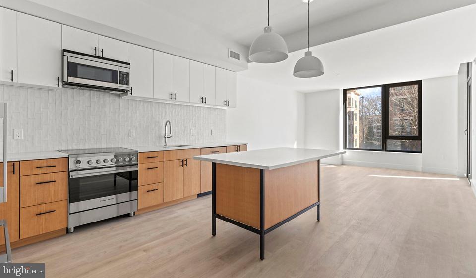 Look-and-Lease Incentive until January 5th 2025. We can honor the current $500 credit to encourage quicker decision-making for moving fees. All T-unit levels will come with a Martha Stewart induction cookware set upon move-in.

2 Months FREE Rent, conditions apply.

Nestled in the heart of Bethesda, Maryland, Ravel and Royale offer an unparalleled living experience that seamlessly blends luxury, nature, and culture. This duo of naturally inspired apartment communities is situated in the vibrant Strathmore Square, providing residents with a truly balanced lifestyle.

Ravel, an intimate boutique community of 49 homes, features sophisticated 2+ bedroom residences with spacious layouts and expansive balconies and terraces that invite the outside in. Royale, on the other hand, offers a diverse range of living spaces from studios to 3-bedroom apartments, catering to various lifestyle needs.

Both properties boast European finishes, generous terraces, and light-filled rooms that create an atmosphere of elegance and comfort. The thoughtfully designed interiors are complemented by an array of exceptional amenities, including a restorative dry sauna, a 24/7 fitness center, and a roof lounge offering sweeping views of the picturesque Rock Creek Park.

Residents of Ravel and Royale enjoy a lifestyle that harmoniously combines urban convenience with natural serenity. The unrivaled location, right at the Grosvenor-Strathmore Metro Station, ensures easy access to the wider Washington D.C. area while being tucked away in a tranquil neighborhood. The proximity to Rock Creek Park provides ample opportunities for outdoor recreation and relaxation, perfect for nature enthusiasts.

The Strathmore Square neighborhood is a haven for art and culture lovers. Through a unique partnership with the acclaimed Strathmore Music Center, residents receive exclusive access to diverse programming, including bi-annual sessions with a Curator Concierge, culturally-rich performances, and early offerings for premier seats. The community also hosts free evening concerts featuring Strathmore Artist in Residence alumni as part of the Music on the Square series, adding to the vibrant cultural atmosphere.

Living at Ravel and Royale means embracing a lifestyle where style, connectivity, and serenity converge. Whether you're unwinding in the restorative dry sauna, enjoying the panoramic views from the roof lounge, or exploring the nearby cultural attractions, every day offers new opportunities for enrichment and relaxation.

The surrounding neighborhood of Bethesda is known for its upscale dining, shopping, and entertainment options, further enhancing the living experience. With the perfect balance of urban amenities and natural beauty, Ravel and Royale provide an idyllic home for those seeking a sophisticated, arts-inspired living environment in one of Maryland's most desirable locations.

** Pricing and availability subject to change on a daily basis ** Photos are of model units ** Parking may be available for an additional fee **