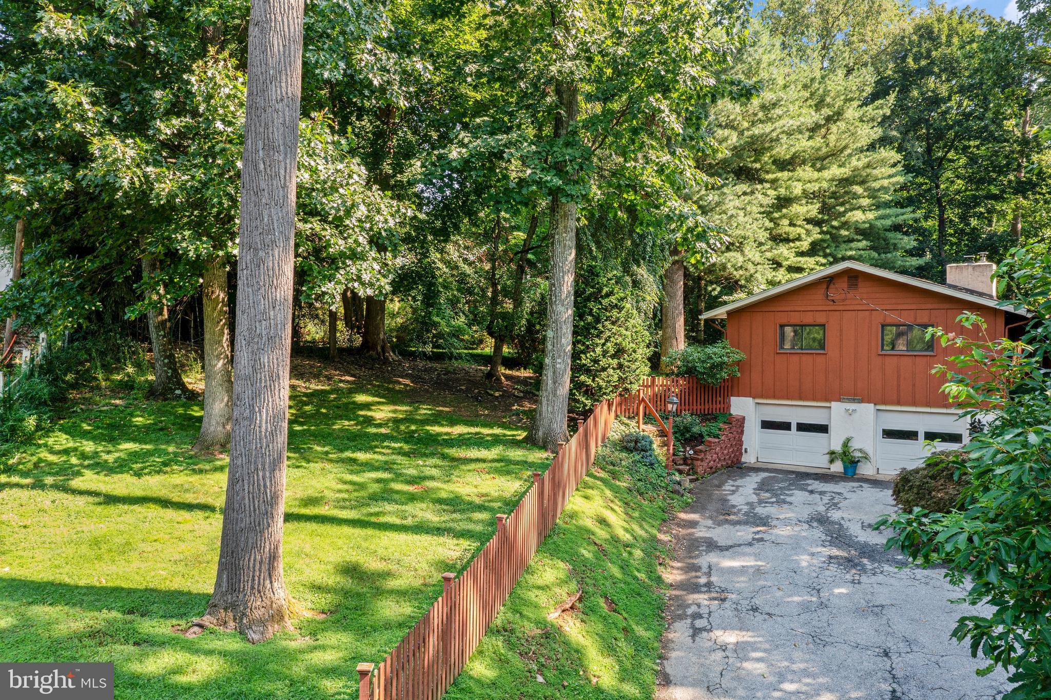 Welcome to a home that surprises at every turn. Set on just under one acre in the privacy of mature trees and greenery, this distinctive bi-level carries the warmth and clean lines of mid-century modern architecture   thoughtfully maintained and rich with personality.

A slate-floored entrance draws you upstairs to the heart of the home, where an eat-in kitchen with a skylight above the sink, warm maple cabinetry, a built-in wine rack, and a peninsula counter with seating sets the tone for easy everyday living. The kitchen opens naturally to the dining area and a sweeping great room anchored by an active wood-burning fireplace. Hardwood floors, crown molding, and oversized windows wrap the space in natural light and lush treetop views, with a glass slider leading out to an expansive deck where you can dine, lounge, and entertain amidst the canopy in complete privacy. Friends of the seller have long called this 'the home in the trees'   and one step outside, you'll understand exactly why.

Three bedrooms are positioned on the upper level, including a corner en suite primary with windows on two walls . The bathroom features a skylight & a sealed steam-shower   a genuine retreat. The second corner bedroom offers the same dual-exposure light. The third bedroom is currently used as a den with hardwood floors and a bold mid-century wall treatment. The hall bath is a standout, featuring a glass vessel sink, green top vanity, classic tile work, and a skylight that fills the space with natural light.

On the first floor, the home opens into a true recreation destination. A handsome wood bar with stools and lighted shelving, a pool table, and a dedicated wine cellar make this the kind of space people remember. The sunroom is wrapped in windows overlooking the grounds, it currently serves as an exercise room and features a working sauna and direct access to the lower patio. The fourth bedroom has two windows which add light & views of the surrounding greenery. It is flexible space that works equally well for guests, a home office, or both. A powder room and laundry complete this level, along with an attached two-car garage tucked neatly into the first floor footprint, a feature that sets this bi-level apart.

The fenced side yard provides open play space to this wooded sanctuary   a rare and lovely combination on 3/4+ acres of private, tree-filled grounds.

All of this in a location that simply works: served by the award-winning Tredyffrin-Easttown School District, walk to the Daylesford train station for an easy commute to Philadelphia, stroll to the Upper Main Line YMCA. Enjoy quick access to the dining, shopping, and conveniences of the Main Line.

This one lives larger than it looks   and feels like nowhere else.