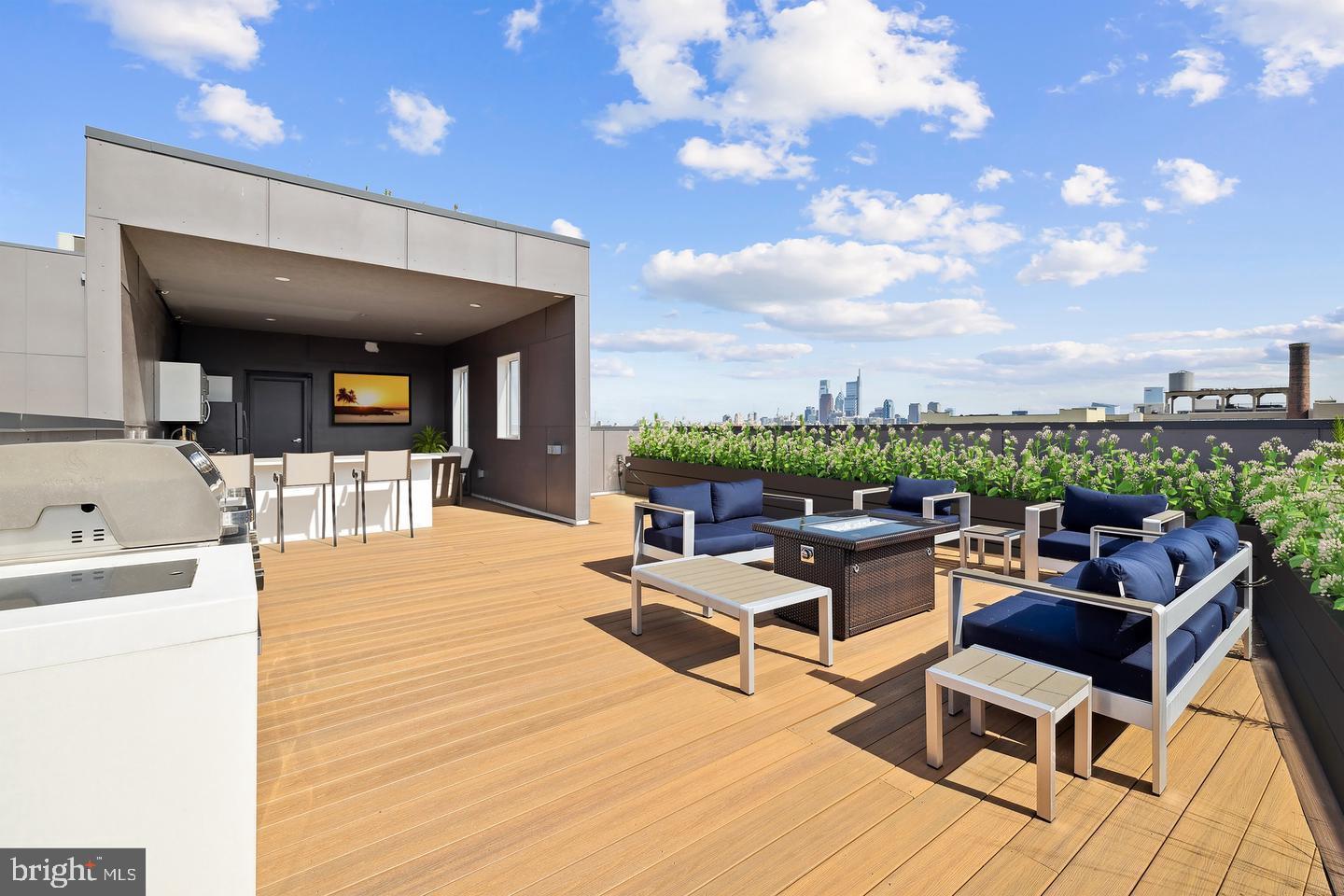 Welcome to Penthouse 12 at OTTO on the Park, a truly exceptional residence offering luxury, privacy, and unmatched outdoor living in the heart of Philadelphia’s thriving Brewerytown neighborhood. Spanning more than 1,700 square feet, this 3 bed, 3.5 bath custom-designed penthouse features three spacious bedrooms, three and a half designer bathrooms, and an expansive open-concept layout highlighted by soaring 10-foot ceilings, wide-plank engineered hardwood flooring, abundant natural light, and premium finishes throughout. The chef-inspired kitchen serves as the centerpiece of the home, showcasing quartz countertops, custom cabinetry, smart appliances, and an oversized island ideal for entertaining. Each bedroom is thoughtfully appointed with custom California Closets, while spa-inspired bathrooms feature heated floors, floating vanities, and sophisticated modern design. Two bedrooms enjoy access to private balconies, and additional conveniences include multiple storage closets, a dedicated laundry area, and a generous mudroom-style entry foyer. What truly sets this residence apart is the extraordinary private rooftop retreat spanning approximately 1,000 square feet. Designed as a personal entertainment and leisure destination, this remarkable outdoor space features a covered full-service outdoor kitchen complete with outdoor-grade cabinetry and appliances, quartz countertops, an island with bar seating, a premium chef’s grill, covered lounge and dining areas, and infrastructure already in place for future lighting and audio enhancements. Built-in structural footings provide the opportunity to further customize the space with an additional pergola, creating an even more impressive outdoor sanctuary with sweeping city views. Residents of OTTO on the Park enjoy an array of upscale amenities including a stunning shared rooftop terrace with dog run, smart building access, secured package room, bicycle storage, dog wash station, and gated onsite parking. Penthouse 12 also includes the rare advantage of two covered dedicated parking spaces (Spots 26 and 27) equipped with electric vehicle charging capabilities. With a few years left on the tax abatement and an unbeatable location just moments from Fairmount Park, the Schuylkill River Trail, Girard Avenue’s vibrant dining and shopping scene, neighborhood cafés, markets, and cultural destinations, this one-of-a-kind penthouse delivers an elevated urban lifestyle that is simply unmatched. Taxes and square footage is the responsibility of the buyer to verify independently.