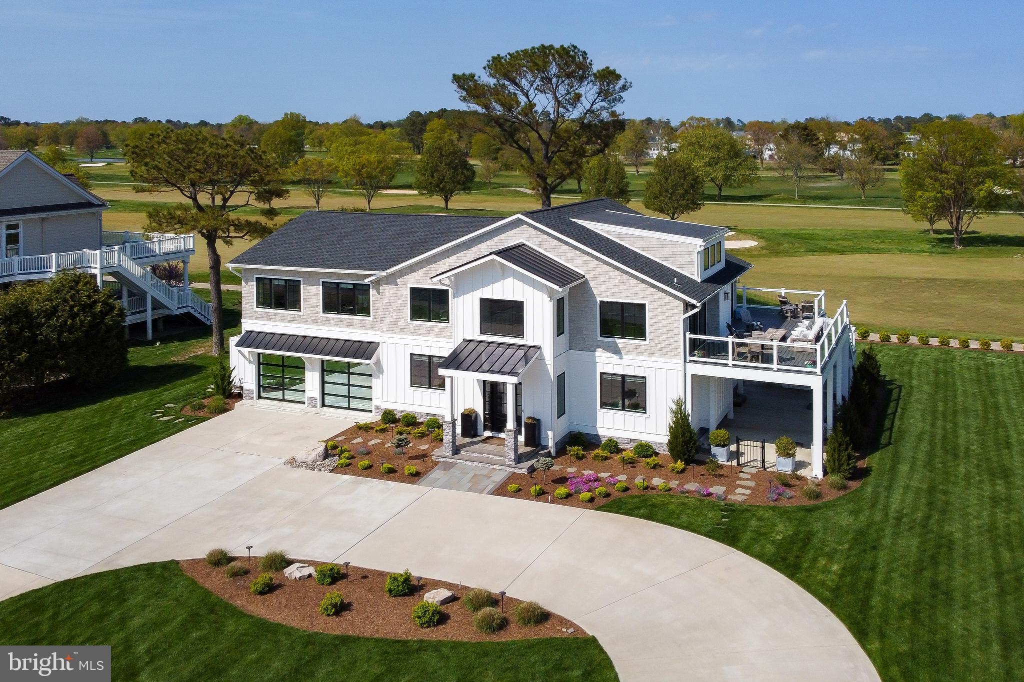 STUNNING Golf Course Home only a stone's throw away from the bay in Rehoboth Beach Yacht and Country Club

This remarkable 5-bedroom, 4-bathroom home in the desirable Rehoboth Beach Yacht and Country Club community offers the perfect blend of luxury, convenience, and breathtaking views. Featuring an inverted floor plan, the home boasts expansive wide views of the Rehoboth Bay from the front and stunning golf course vistas from the rear. The completely renovated home in 2021 showcases an open floor plan flooded with abundant natural light, high-end finishes, and the perfect amount of living space. Enjoy the spacious second-level side deck overlooking the bay or the paver patio with a built-in fire pit in the backyard while providing ample opportunities for outdoor entertaining and relaxation. Situated on an oversized lot just three lots from the country club, this home offers unparalleled convenience for those interested in joining the club. This exceptional property is sure to appeal to the most discerning of buyers, offering the perfect blend of luxury, comfort, and stunning natural surroundings. Community open space across the street along the bay ensures your unobstructed bay views will remain indefinitely.  Don't miss the opportunity to make this your new dream home in Rehoboth Beach.