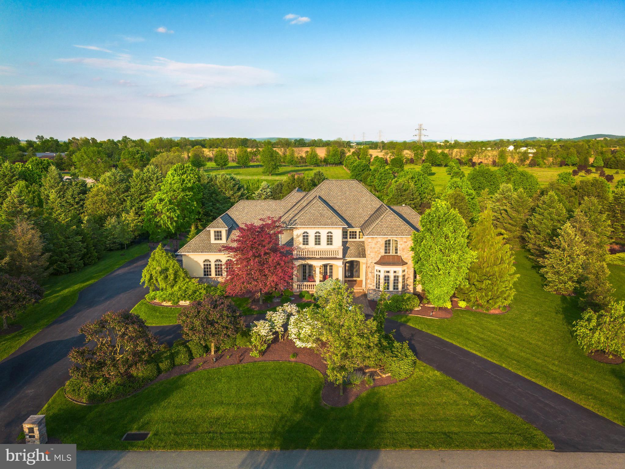 Get ready to be impressed, your Search Ends Here! Pride of Ownership is evident in this Custom Built 5 Bedroom, 5.5 Bath Colonial situated on a Premium Lot in the Exclusive Stonebriar Neighborhood of Desirable Bethlehem, Pennsylvania. Mature Landscaping and Premium Property Placement create a sanctuary of peace & privacy all year-round! Beautiful stucco & stone accented exterior, impressive circular driveway, and inviting Front Porch set the stage for quality - upon entering the Grand Foyer, you're welcomed with tasteful neutral paint and stunning travertine tile floors flowing throughout the majority of the First Floor. Open Floor Plan greets you and leads you right into the Formal Dining Room with elegant chandelier - Perfect for Entertaining Family and Friends. Two-Story Family Room boasts coffered ceiling, beautiful stone fireplace with mantle and large hearth and is overlooked by the breath-taking Eat-In Kitchen, enjoy top of the line stainless steel appliances, custom cabinetry, tile backsplash w/pot filler over the stove, custom leather granite countertops, large walk-in pantry, and enormous center island with barstool overhang and additional storage. Kitchen area also includes large Sun-Soaked Breakfast Room overlooking the serene Backyard Oasis. Down the Hall, Large Executive Office with glass doors and custom built-ins creates the perfect space to Work From Home! First Floor Grand Master Bedroom Suite includes Sitting Area, Impressive Walk-In Closet, Private Updated Ensuite Master Bathroom. Master Bathroom is sure to impress with two separate vanities, stall shower, soaking tub, and linen closet. Also on the 1st Floor you'll find the Half Bathroom & the convenient 1st Floor Laundry Room. Upstairs, 4 generously sized Bedrooms and 3 Additional High-End Full Bathrooms make up the rest of the 2nd Floor! Great for large families or those who love to host! 2nd Floor also boasts a large loft area that can be used as another space to work from home and a 2nd Laundry Room for ultimate convenience. No detail has been missed! Downstairs, the Fully Finished Basement features recessed lighting, built in bar area, and an additional 5th Full Bathroom with stall shower. So much room to grow and create an additional family room, home gym, guest suite, etc - the possibilities are endless! The Basement also includes plenty of additional storage space and walk-out entrance to the Garage. Outside, the Huge Backyard is Fully Fenced and boasts beautiful In-Ground Gunite Saltwater Pool with stone accented waterfall feature and connected hot tub with additional waterfall feature. Other backyard features include  extensive patio area, mature landscaping with gazebo and built in outdoor kitchen area with granite countertops, barstool seating, built in beverage fridge, and built in grill. The ultimate luxury experience! Perfect for those who love their vehicles - oversized 3 Car Garage with room for Additional Storage. With Custom Finishes from Top to Bottom, this home is sure to please and have room for everyone to enjoy! Great Location. Close to Major Highways, Public Transportation, Shopping, Restaurants, Highly Rated Golf Courses, Parks & Schools!