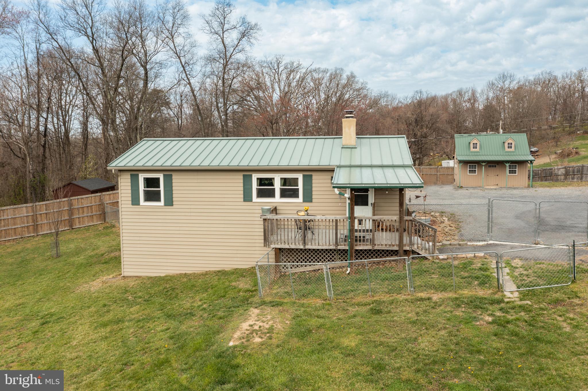 Offer deadline:  March 31, 2025 6pm EST
Charming 2-Bedroom Home with Mountain Views – No HOA!

Nestled in the scenic Shenandoah Farms community and close to the Shenandoah river, this home sits on a spacious fully fenced lot, offering privacy and tranquility. Upgraded in 2017 with durable Craneboard siding and a Standing Seam Metal Roof System, this home is built to last. The gated driveway entrance adds security, while two versatile outbuildings provide endless possibilities—one perfect for a workshop, s/he shed, or extra storage, and the other ideal for a garden shed. Inside, you’ll love the solid oak kitchen cabinets, an inviting open-concept great room, and a cozy wood-burning fireplace. Enjoy breathtaking mountain views and sunrises right from your front porch. Located close to the Shenandoah River, this home also offers water access less than a mile away, making it an ideal retreat for canoeing, kayaking. Outdoor enthusiasts will love the proximity to Shenandoah National Park, Sky Meadows State Park, and Thompson Wildlife Management Area, which provides public land access for hunting, fishing, and hiking at the top of the mountain.  This property is a perfect starter home or investment opportunity—don’t miss out! Schedule your showing today!