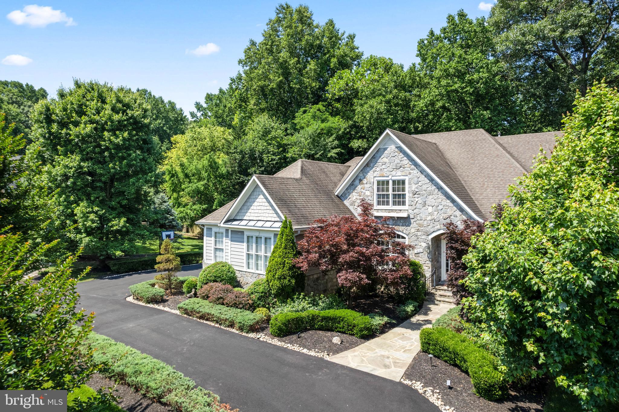 Welcome to the luxurious and coveted Symphony Meadows in Vienna. This custom-built Sekas home is uniquely designed with a sunroom and a main-floor master bedroom, offering over 6,500 square feet of luxury living. Located on a private cul-de-sac, it features a freshly done circular driveway connected to the main drive and house. Custom landscaping with a programmable sprinkler system and lighting creates a beautiful ambiance throughout the nearly one-acre lot. The spacious side yard offers potential for a pool. Inside, a Bose surround sound system enhances the main floor's elegance. Enjoy a close walk to the gorgeous Meadowlark Gardens and the convenience of living in the Symphony Meadows community, with Fiore Montessori School next door. Ride your bike on the nearby W&OD trail and be minutes away from Wolf Trap and Tyson's Corner.

Upon entering, you're greeted by a grand foyer with soaring vaulted ceilings. To the right, French double doors lead into a home office with custom shelving and large double windows, providing plenty of natural light. Across the hall is a grand dining room, perfect for hosting dinner parties, game nights, and family dinners. The gourmet kitchen features an island/bar with granite countertops, ample counter space, and a bar area for casual dining or coffee chats. The adjacent pavilion room offers nearly 360-degree views and abundant natural light, making it an ideal spot for reading, working, or enjoying a morning coffee in the stunning sunroom with a gas fireplace.

The main living room, with its beautiful hardwood floors, vaulted ceilings, and a two-story double-sided stone fireplace, is a showpiece of the home. Custom window treatments add to the space's sophisticated appeal. Down the hall, the primary bedroom suite features a double-sided gas fireplace, balcony access, and a luxurious private bathroom. The main level also includes a second bedroom, a full bath, a mudroom with a full-size washer and dryer, a half bath, and ample closet space.

The second level offers two spacious bedrooms with large custom closets and bay windows, sharing a Jack-and-Jill bathroom. The full walkout lower level includes a stone patio for outdoor hosting, two additional bedrooms, a wet bar, a home theater, and a spacious recreation room for various activities. An unfinished storage area and a full bathroom complete the basement.

Symphony Meadows is a friendly neighborhood with annual events and activities, fostering a strong sense of community. Across the street, Meadowlark Botanical Gardens offer beautiful scenery and event venues, while Wolf Trap provides an array of concerts throughout the year. Quick access to the Toll Road/Rt 495, Tyson's Corner, parks, trails, Washington, DC, and Dulles International Airport adds to the home's appeal. This Symphony Meadows home is more than just a place to live; it offers a luxurious lifestyle with unmatched comfort and convenience. Welcome home!