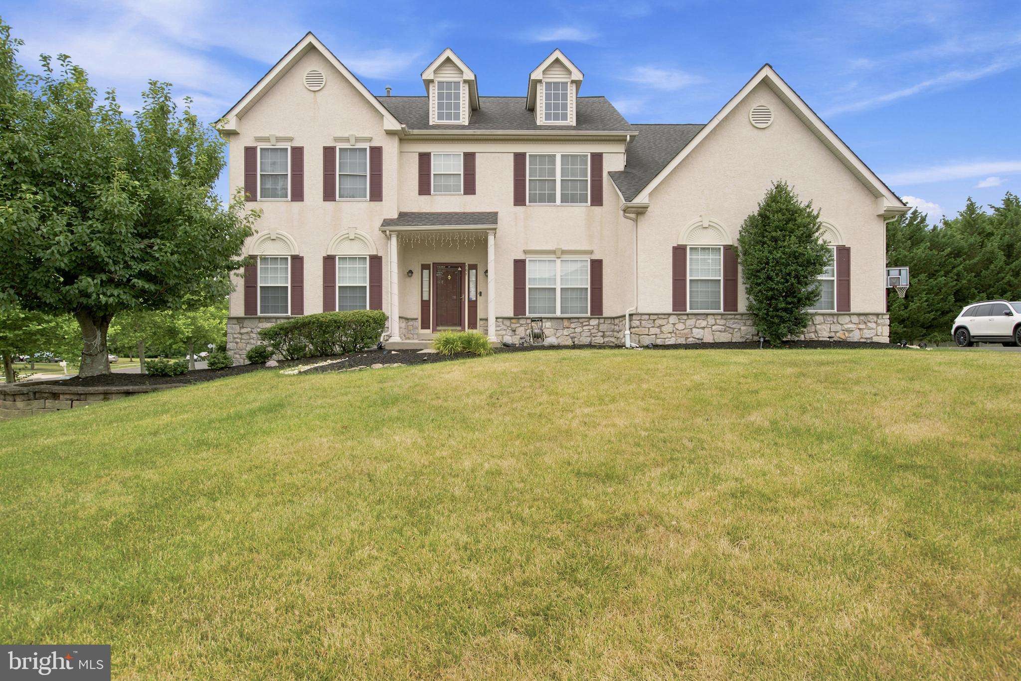 RARE FIND IN MONTGOMERY CROSSING! Welcome to this magnificent, East-facing, Vastu-compliant 4-bedroom colonial built by the David Cutler Group in the award-winning North Penn School District (Gwyn-Nor Elementary). This exceptional home seamlessly blends classic elegance with a massive list of high-end, modern structural and technological upgrades. Step inside a grand two-story center foyer flanked by formal living and dining rooms featuring elegant crown molding. The gourmet kitchen is a chef’s dream, boasting an upgraded center island and perimeter surrounds wrapped in premium granite stone, a steel dual-basin sink, 42" cabinetry, and a bright breakfast area. The kitchen flows effortlessly into a spacious family room anchored by a cozy gas fireplace. For tech enthusiasts, this home is fully modernized with Cat6 Ethernet cabling and Google Nest cameras/smart Wi-Fi coverage across all three finished floors. The spectacular living space extends into a fully finished basement, designed as the ultimate entertainment zone. This massive lower level features an open home theater area, a convenient kitchenette/bar area, a fully renovated full bathroom, and dedicated storage space. For total peace of mind, the basement is protected by a dual sump pump system equipped with a brand-new battery backup. Mechanically, the home is completely turn-key and worry-free, featuring a brand-new air conditioner and heating system (HVAC - both under warranty), alongside a brand-new water heater. Upstairs, the sprawling primary suite serves as a private retreat with vaulted ceilings, walk-in closets, and an en-suite bath, complemented by a full hall bath. Outdoor living is a true highlight: sliding glass doors lead to a massive, premium 20'x40' custom stone patio beautifully framed by professional landscaping and gas line connection for BBQ—perfect for hosting large summer gatherings. The exterior is completed by an extended driveway offering ample parking and a matching 10'x12' external storage shed. Located at a prime location of Montgomery County,  NO HOA fees and minutes from Costco, Bj's, Wegmans, Whole Foods, along with lot more other shopping options near Montgomery Mall,  local train stations and a convenient access to most of the highway routes, this smart, upgraded home is an absolute must-see!