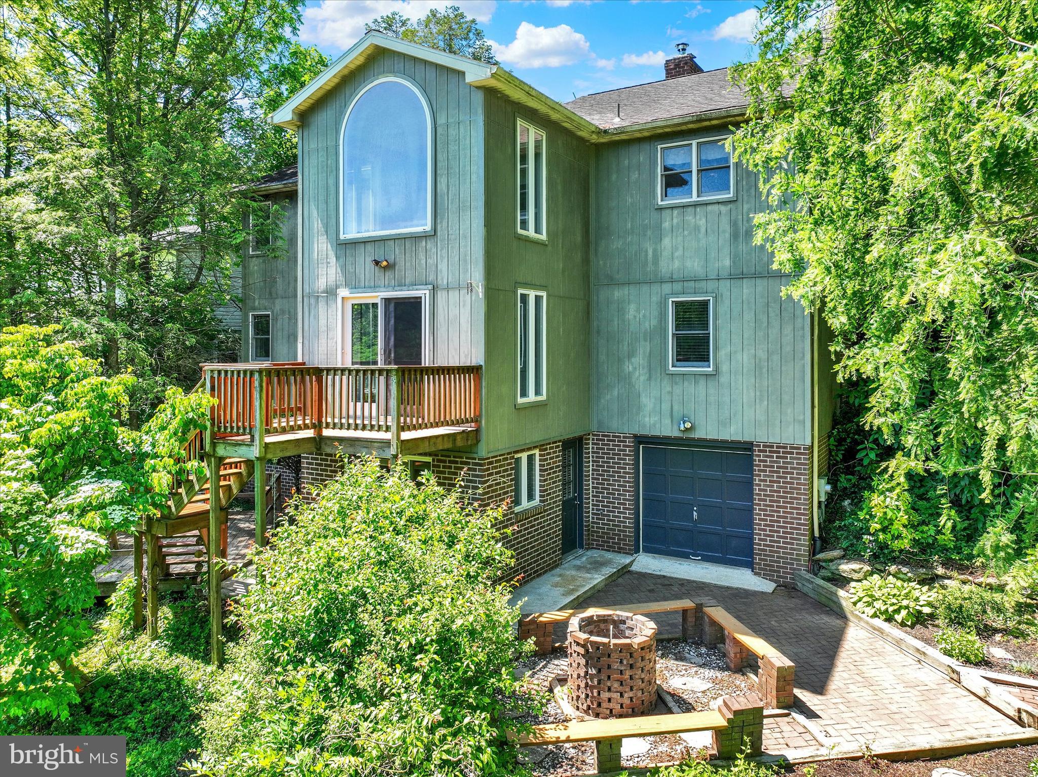 Don’t judge this home by its front view. It may appear to be a rancher at first glance, but step inside and discover a home full of surprises, space, and possibilities spread across three levels of living space, with a rear-oriented design that takes full advantage of the natural surroundings. There’s also room for future expansion! Enter through the ceramic tile foyer and immediately appreciate the openness of the home as it flows into a dramatic cathedral ceiling great room combining living and dining spaces, while a loft-style overlook, from the dining area, draws your eye to the oversized window showcasing scenic views. The spacious kitchen offers abundant cabinet and counter space, stainless steel appliances, and convenient access to the garage. Just beyond the garage, a separate mudroom offers space to keep outdoor gear organized. Conveniently located on the main level, the primary bedroom includes a walk-in closet and private access to the full bath, for added functionality and ease of living. The exposed lower level is filled with natural light thanks to oversized windows. It features a large family room anchored by a fireplace, with woodstove insert, and direct access to the rear deck and outdoor living areas. There are also two additional bedrooms, and a full bath, with a laundry closet. Adjacent to the family room is a versatile step-down bonus room with a pass-through window, full bath access, entry to two unfinished storage rooms, and access to yet another exposed lower level featuring three additional rooms offering flexibility for a variety of uses. Existing spaces include a window-filled room, with patio access, that works well as a sunroom or office, plus opportunities for additional bedrooms, entertaining areas, hobby space, workout room, or whatever else you can dream. One room provides access to a 10x10 service garage, adding extra functionality and storage options. Outside, a lush semi-private backyard framed by mature trees offers decking and patio space for relaxing, entertaining, gardening, or simply enjoying the scenery. With abundant outdoor space and a versatile layout, there is also plenty of opportunity to create your own backyard retreat with a future in-ground pool. Located along a cul-de-sac street, in Dallastown Schools, and just minutes to I83 Exit #14/Leader Heights. Unique homes don’t come along often! Explore the possibilities and make this one your own!  AGENTS - Please read Agent Remarks before showing property.